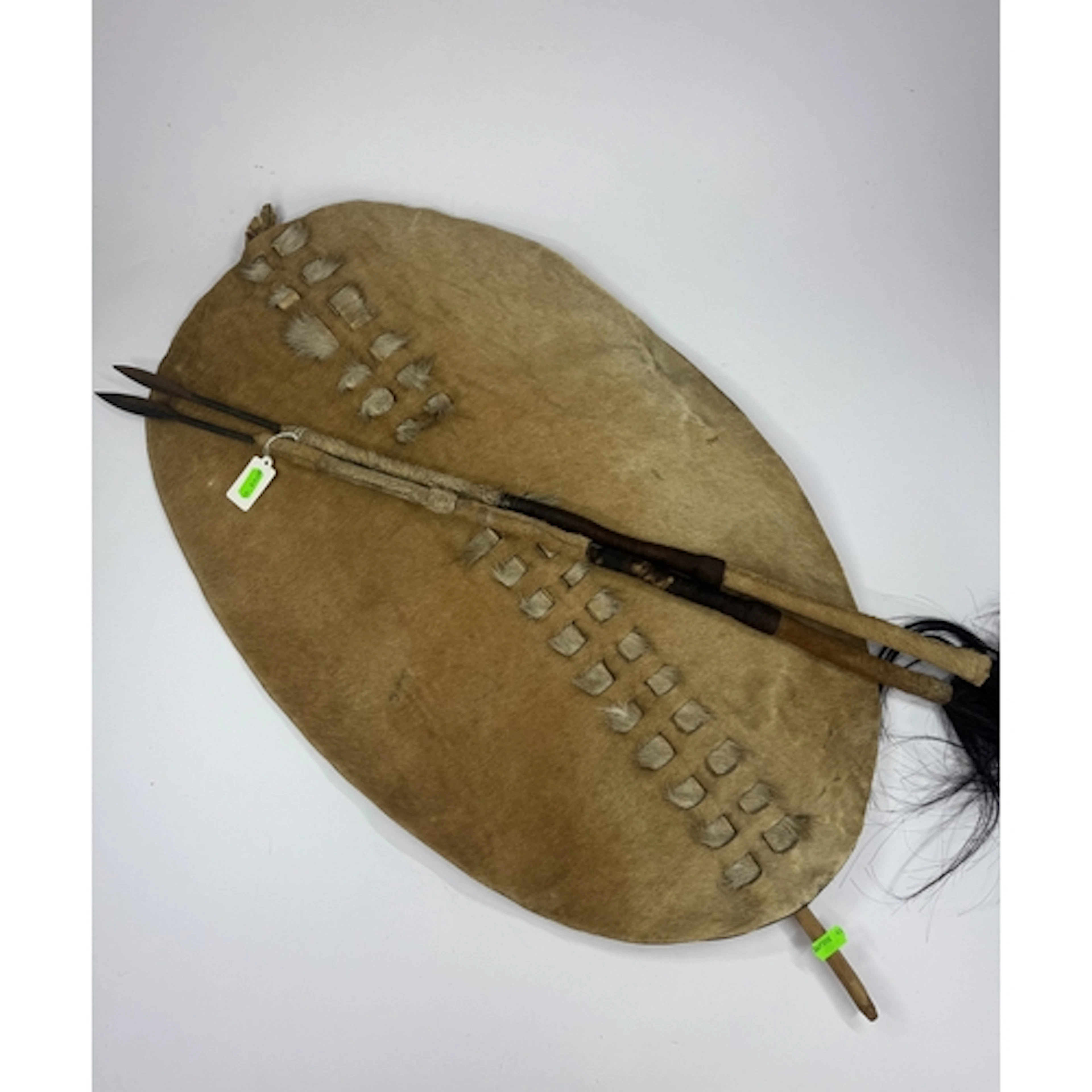 Tribal Arts: a Zulu cow hide ishilangu shield, 67cm by 42cm,...