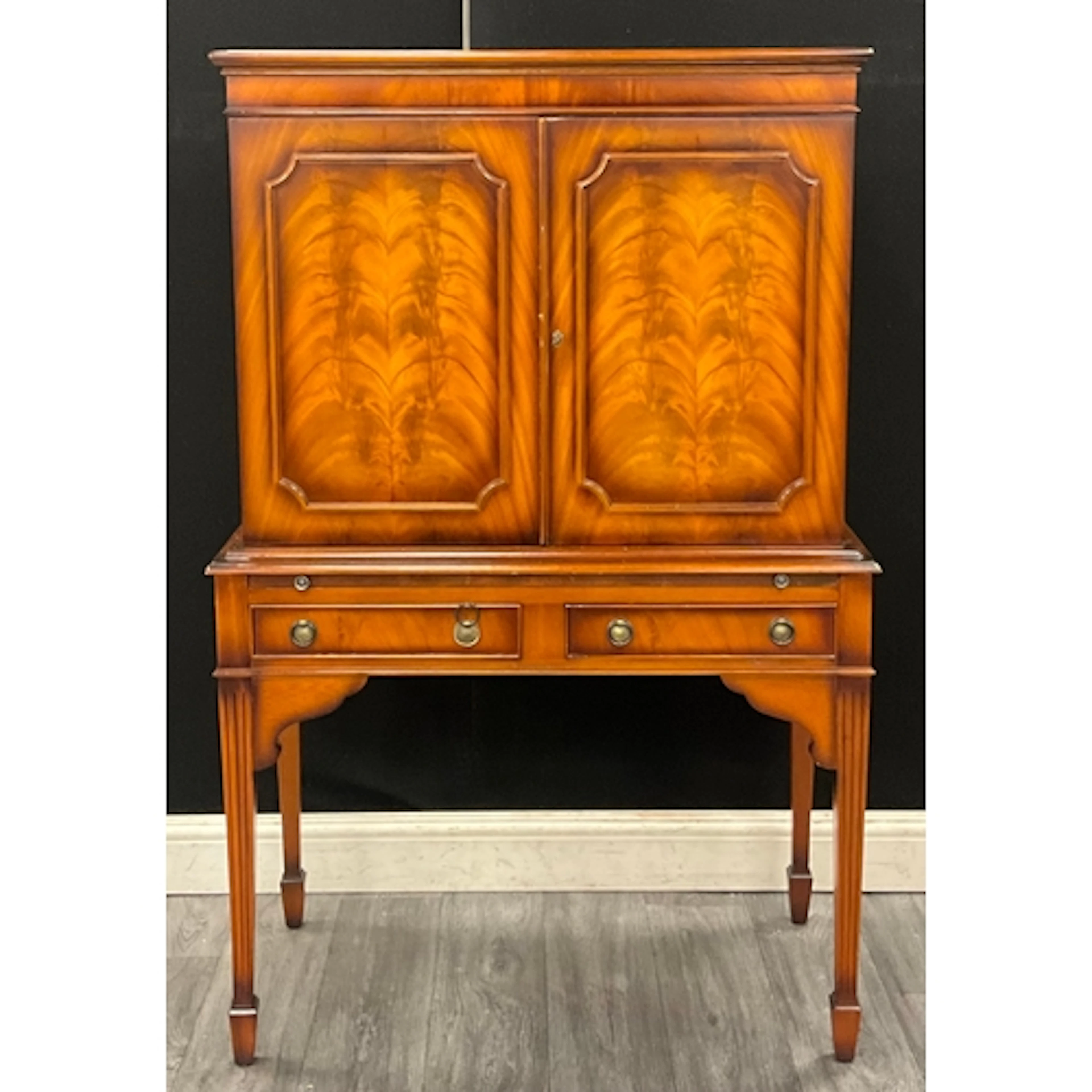 A George lll style Mahogany Cocktail Cabinet crowned by a st...