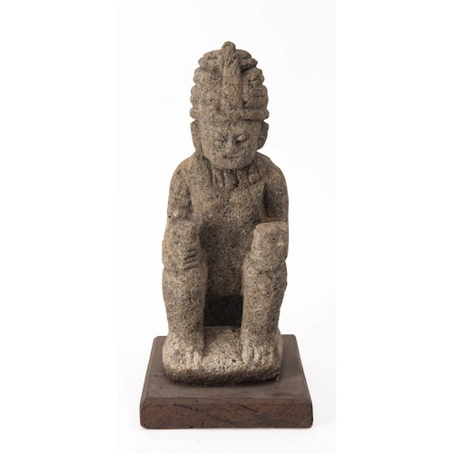A reproduction Mesoamerican chac mool model of a reclining f...