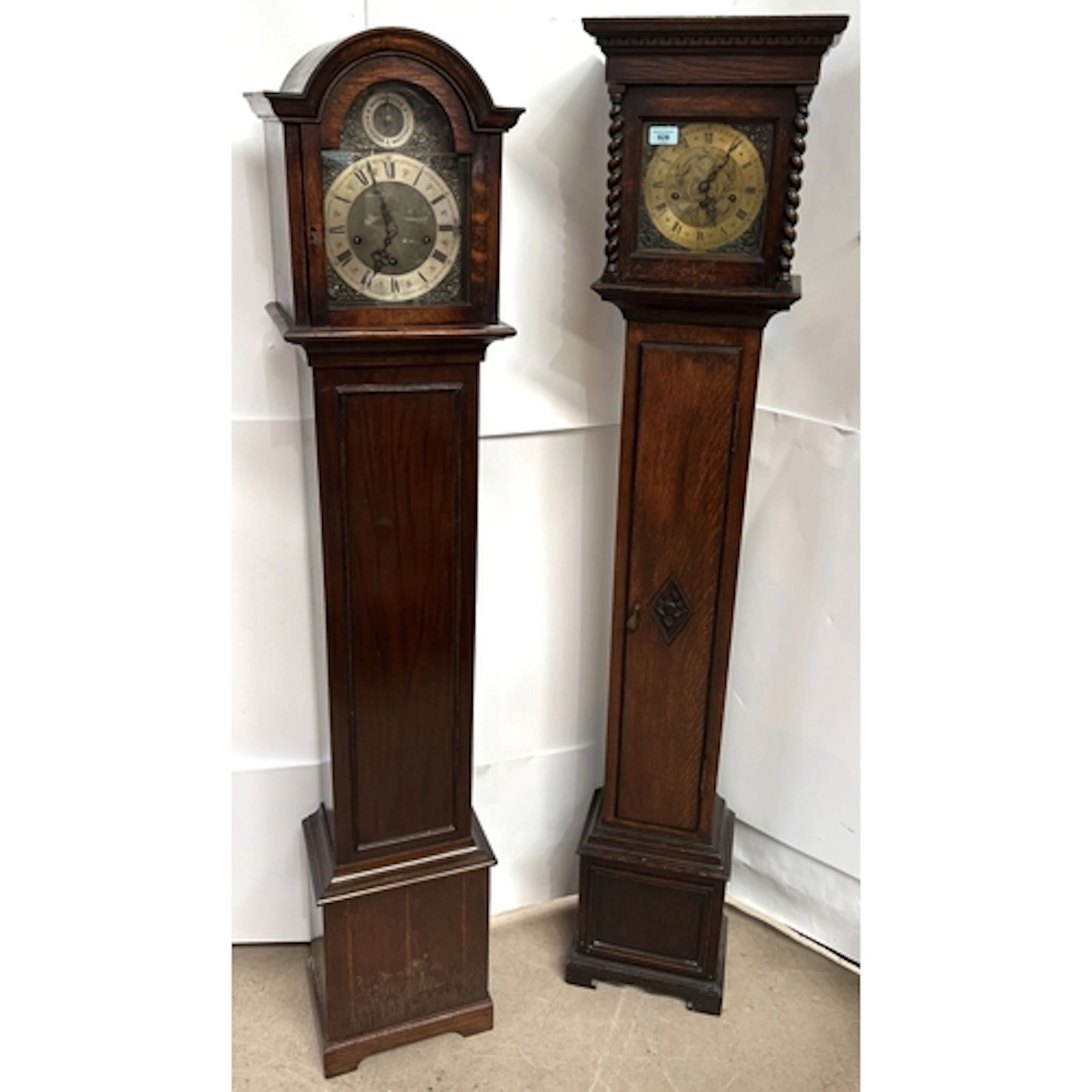 Two oak long case grandfather clocks both with chiming movem...