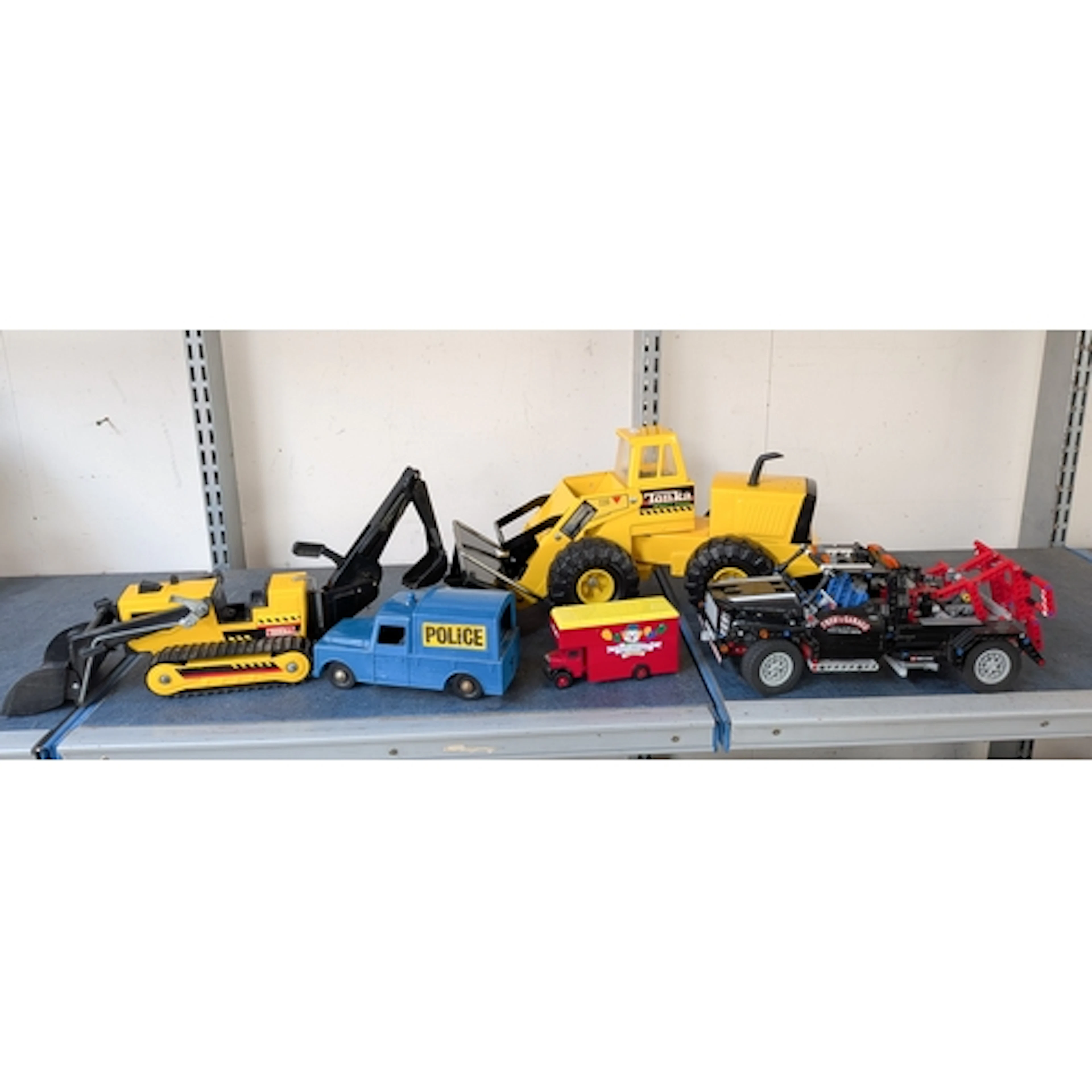 A metal Tonka mighty diesel front end loader toy together wi...
