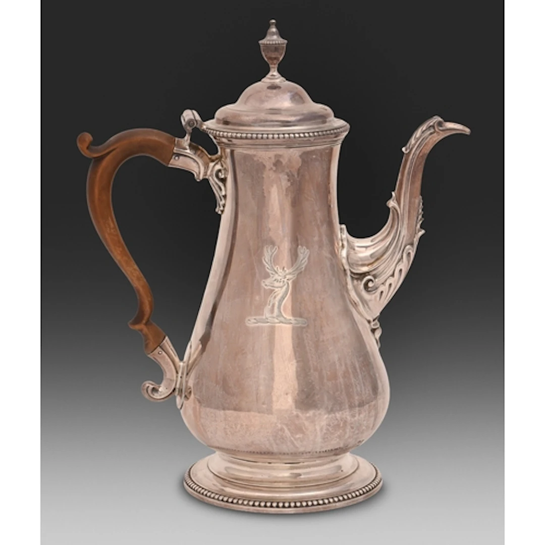A George III silver coffee pot, with urn finial to the ogee ...