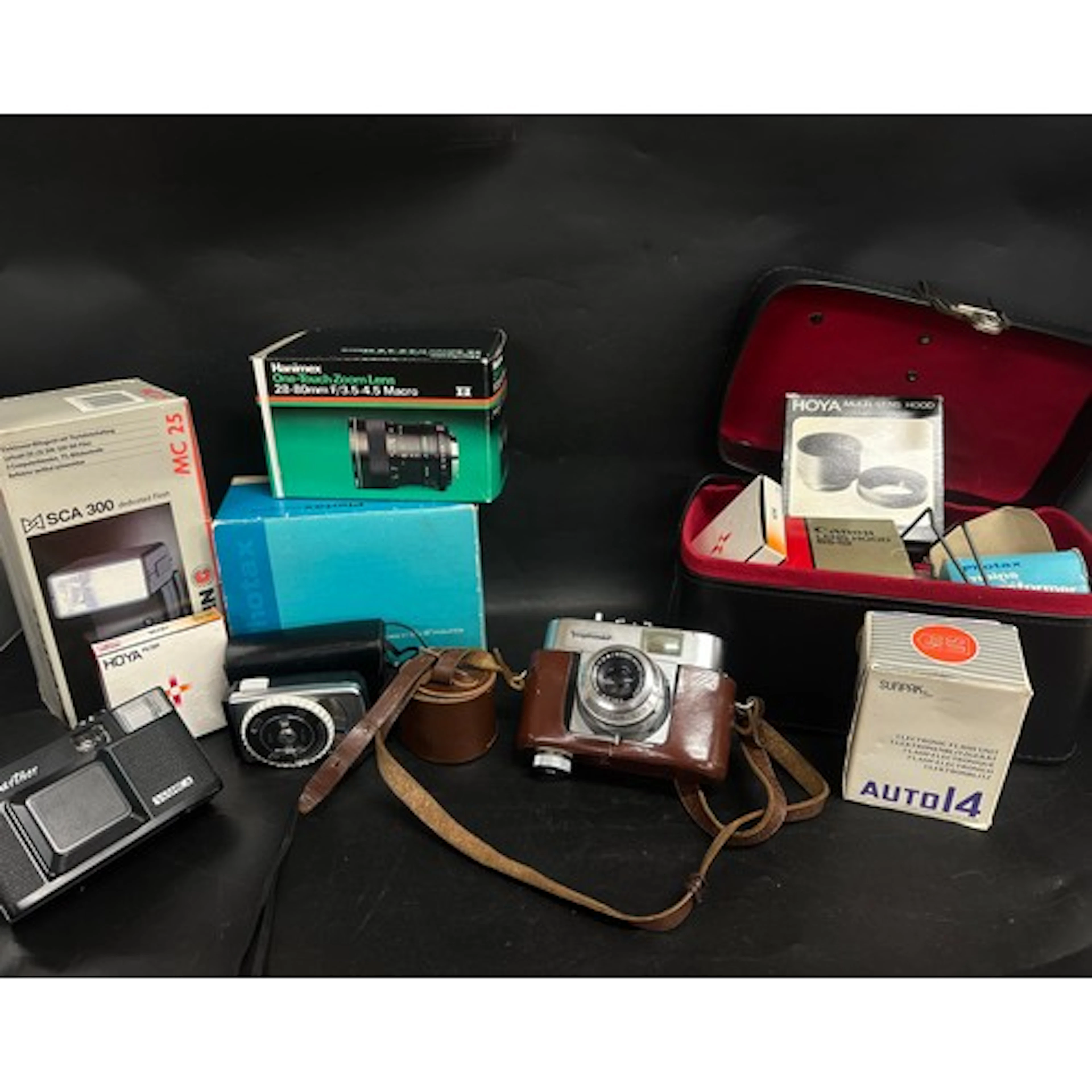 A collection of cameras including a Voigtiander color skepar...