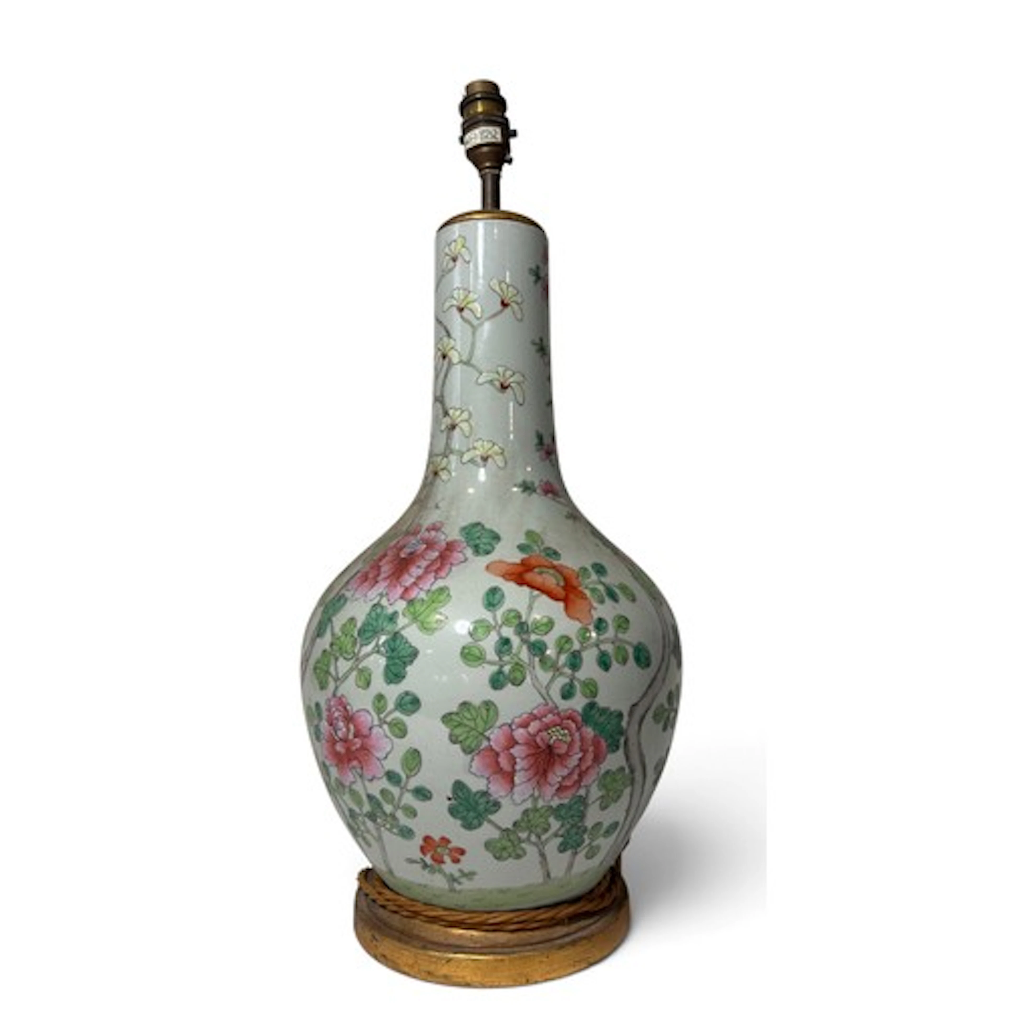 A Chinese famille rose bottle vase with floral detail, prese...