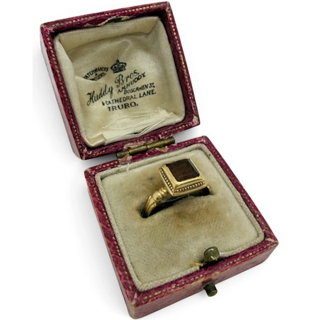 A gold ring, centred by a rectangular table-cut hessonite ga...