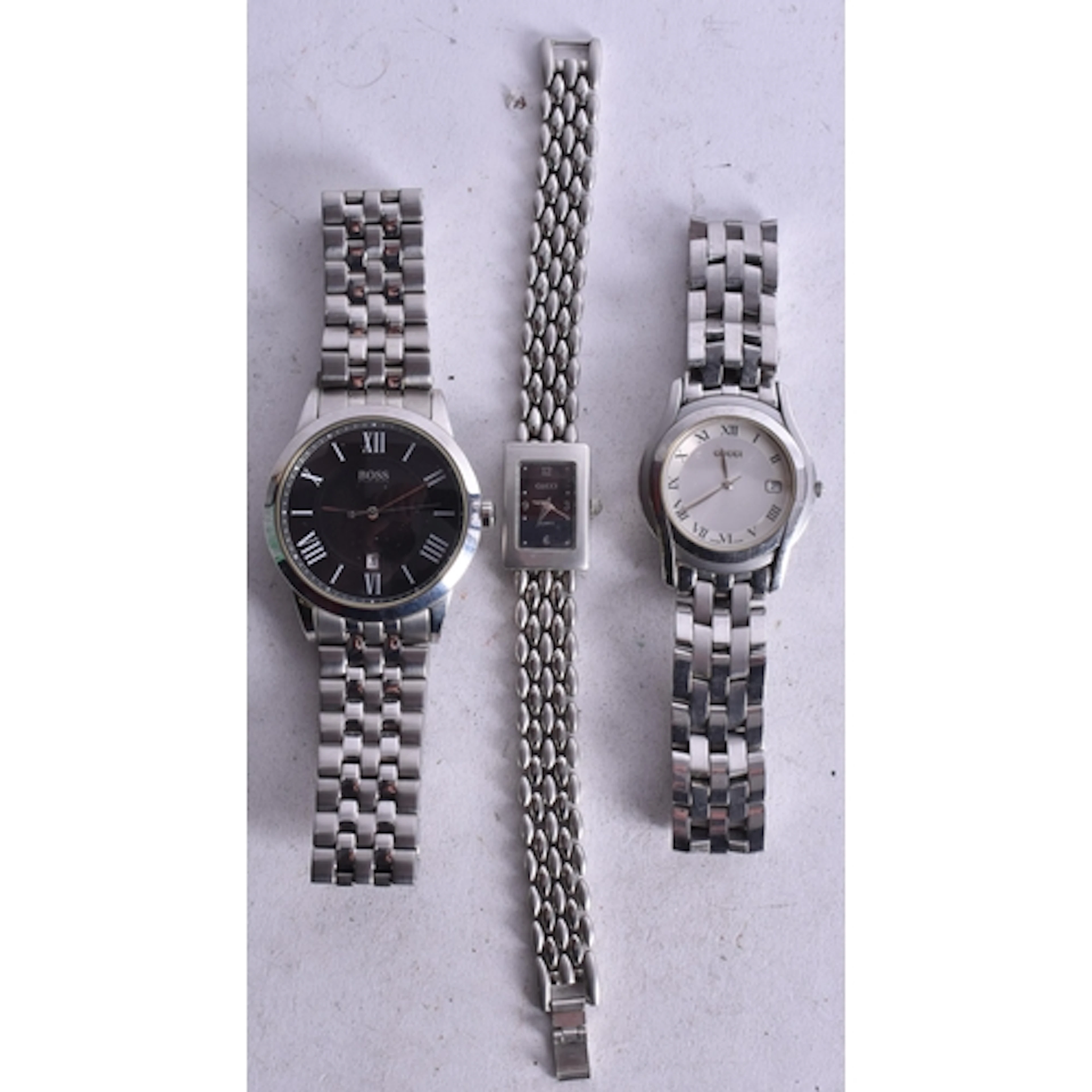 TWO GUCCI WRISTWATCHES and a Boss watch. Untested. 4.5 cm wi...