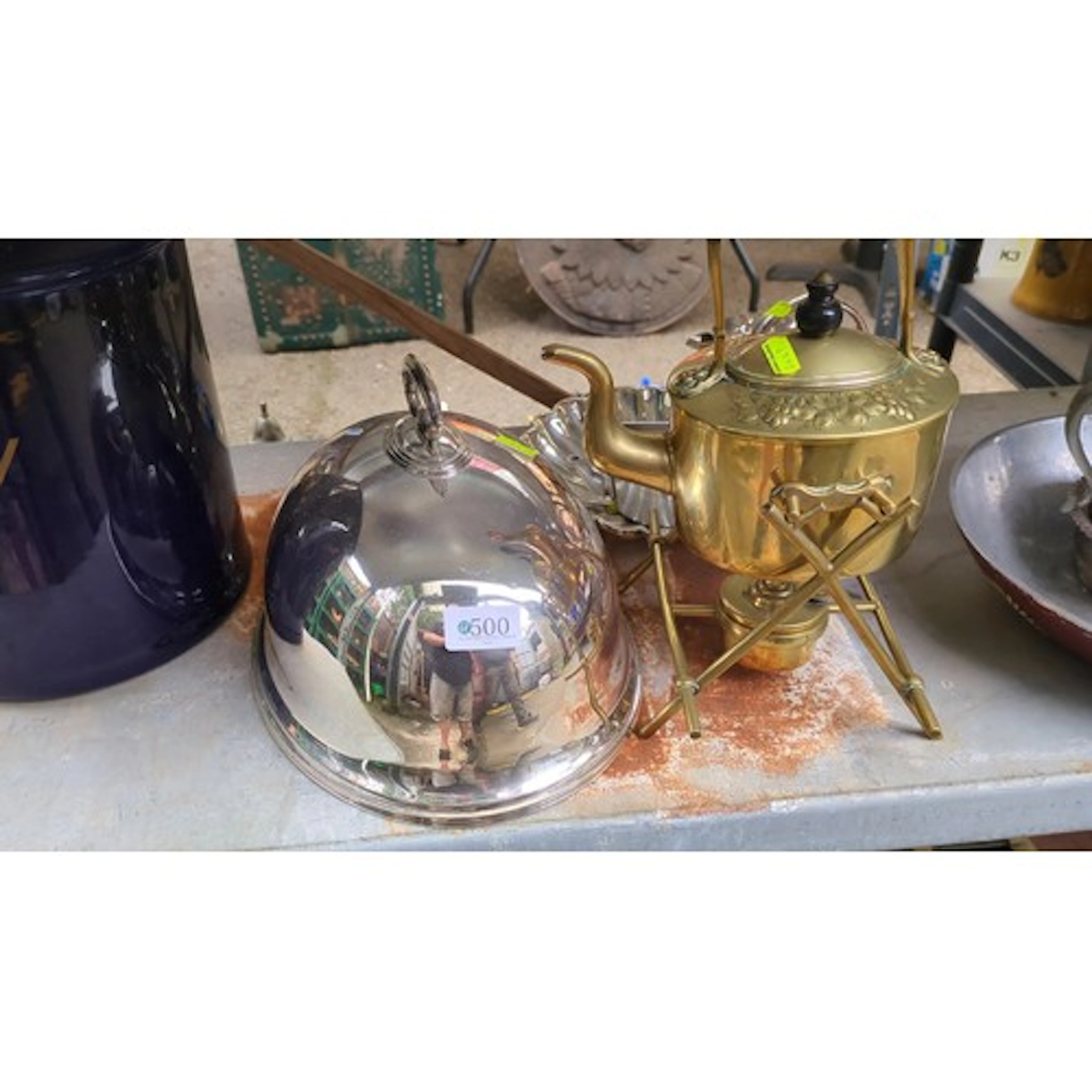 A group of mixed metal table wares including a domed serving...