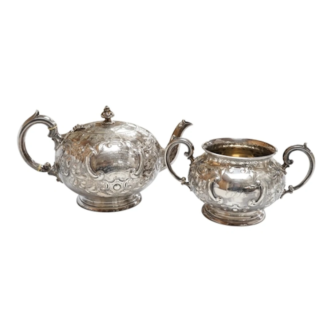 A Victorian silver teapot and twin handled sugar basin Sheff...