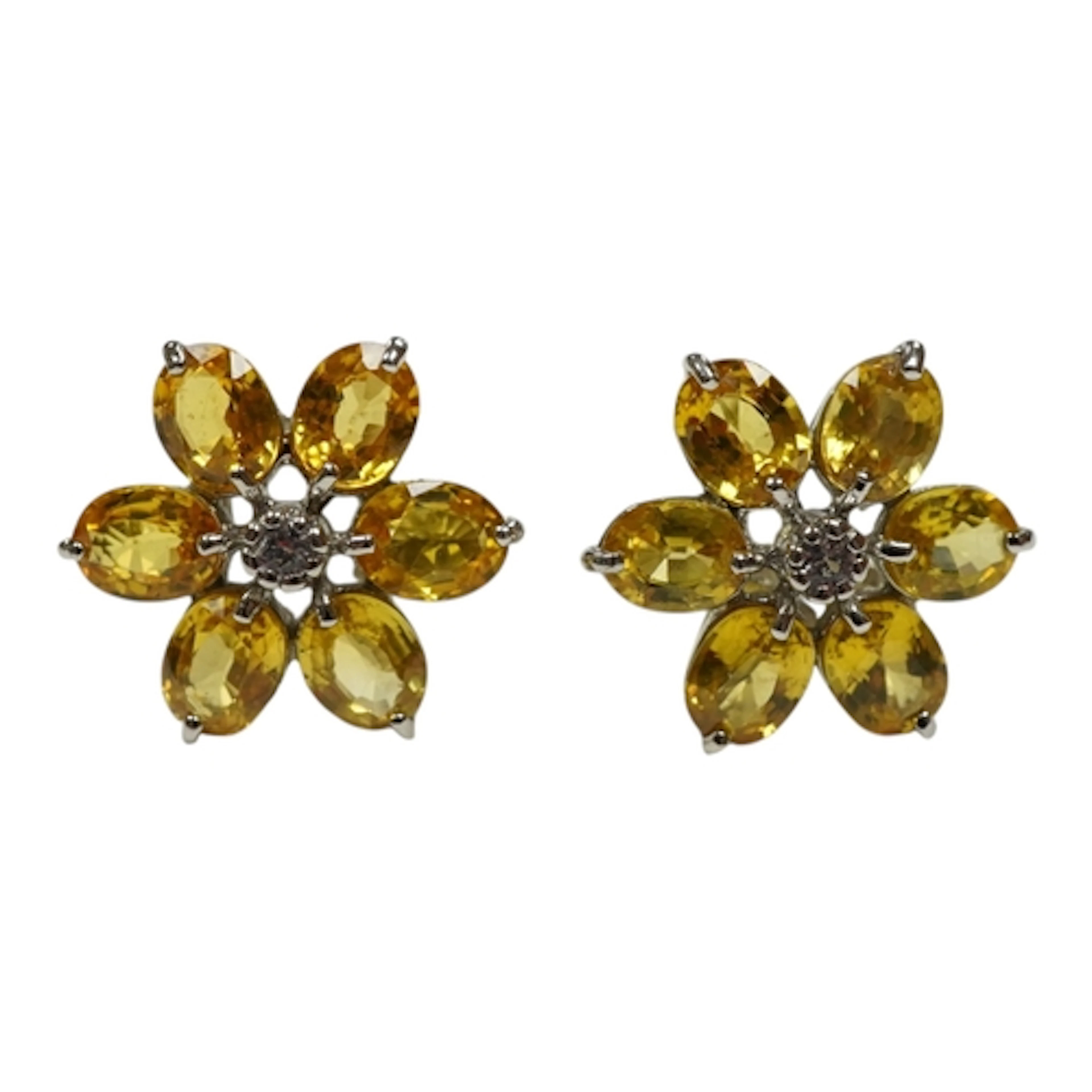 A recent pair of 9ct white gold and yellow sapphire cluster ...