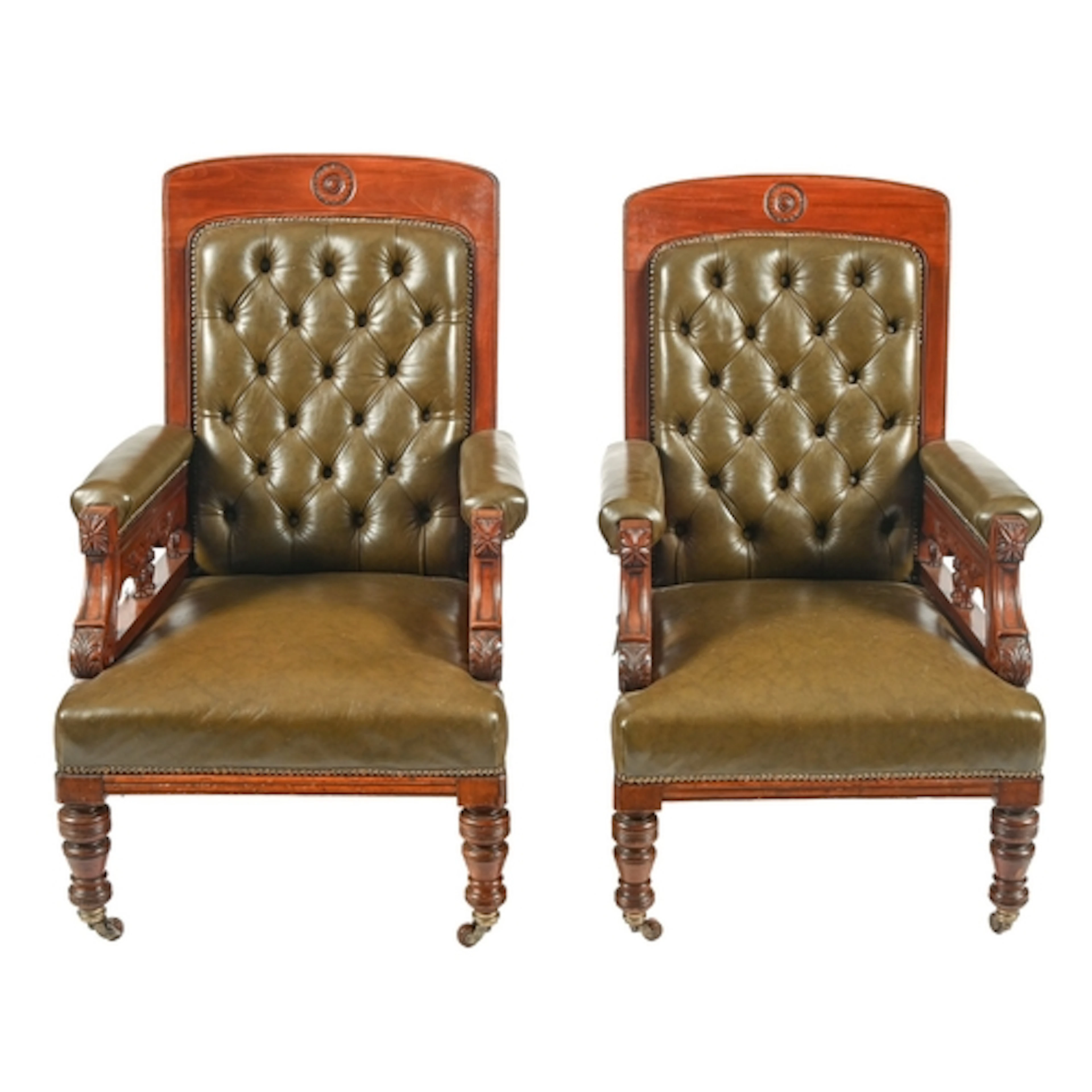 A graduated pair of Victorian mahogany armchairs, the slight...