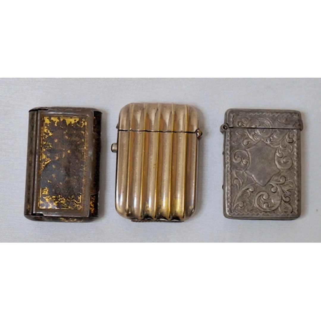 3 Vesta Cases, pewter, ribbed chrome etc. (3)