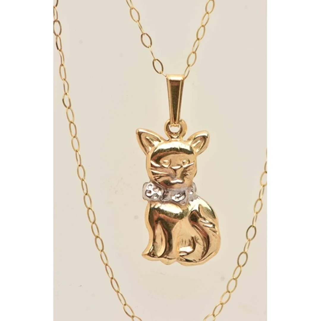 A YELLOW METAL CAT PENDANT NECKLACE, the hollow cat pendant ...