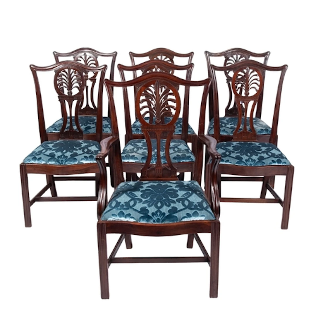 A set of seven George III mahogany dining chairs, the backs ...