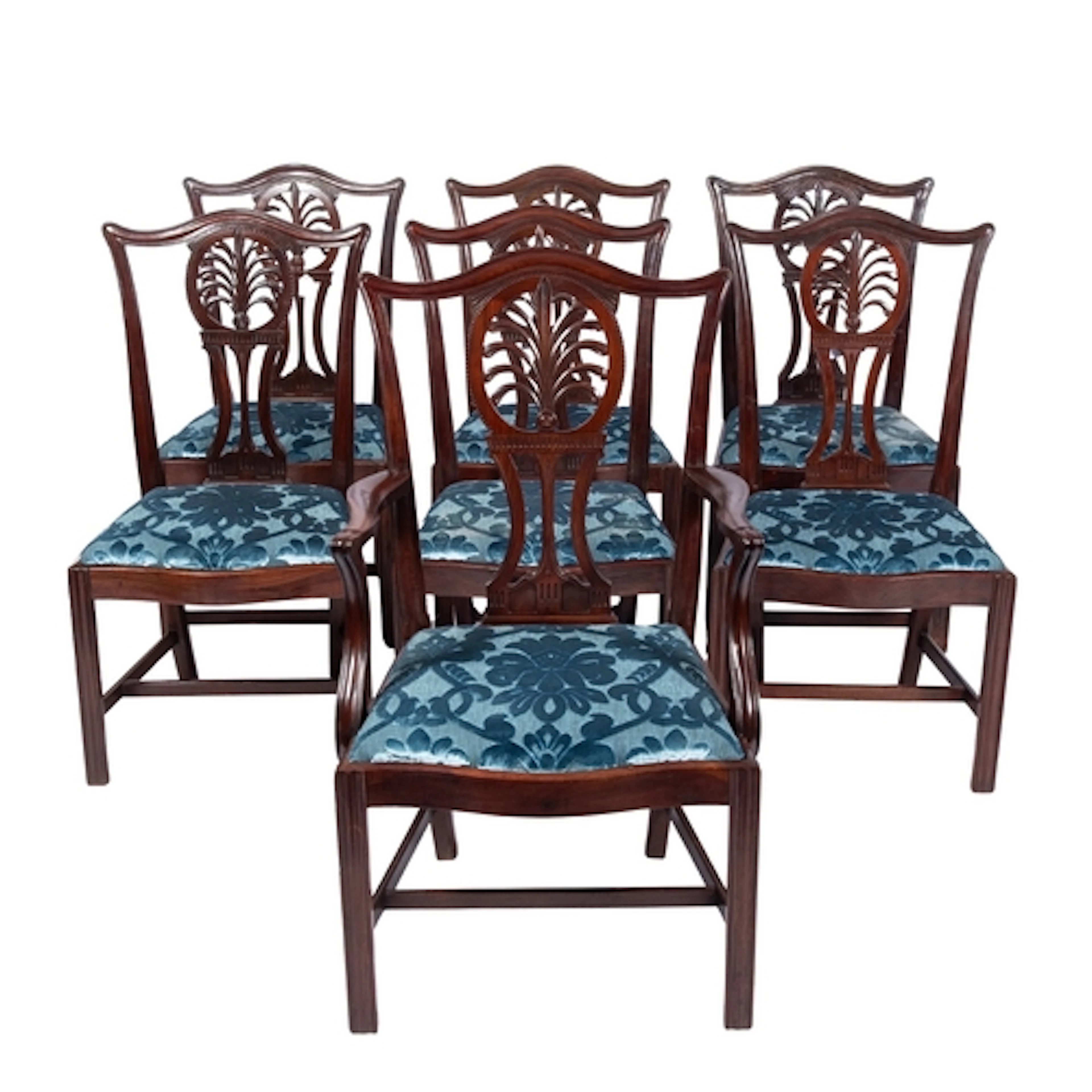 A set of seven George III mahogany dining chairs, the backs ...