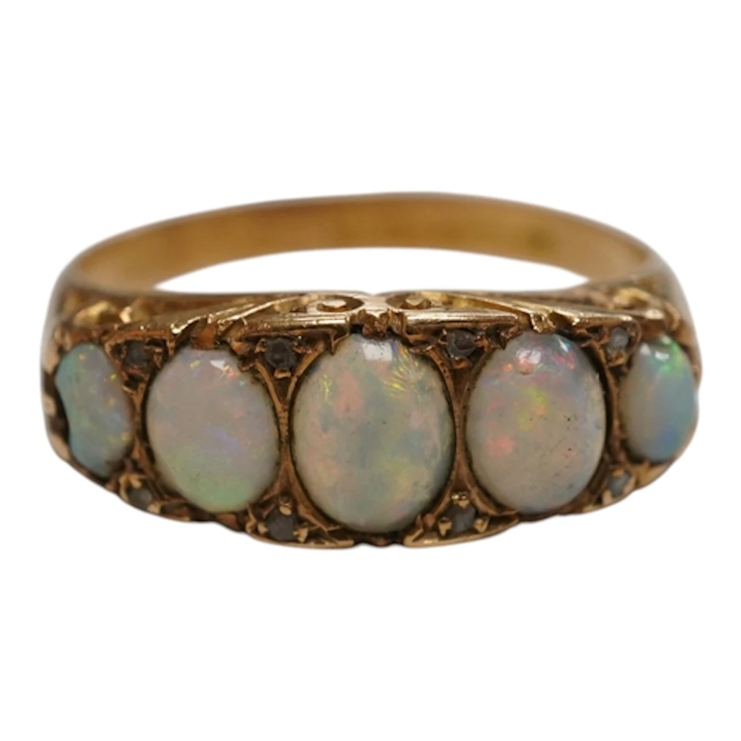 A George V 15ct gold and graduated five stone opal half hoop...