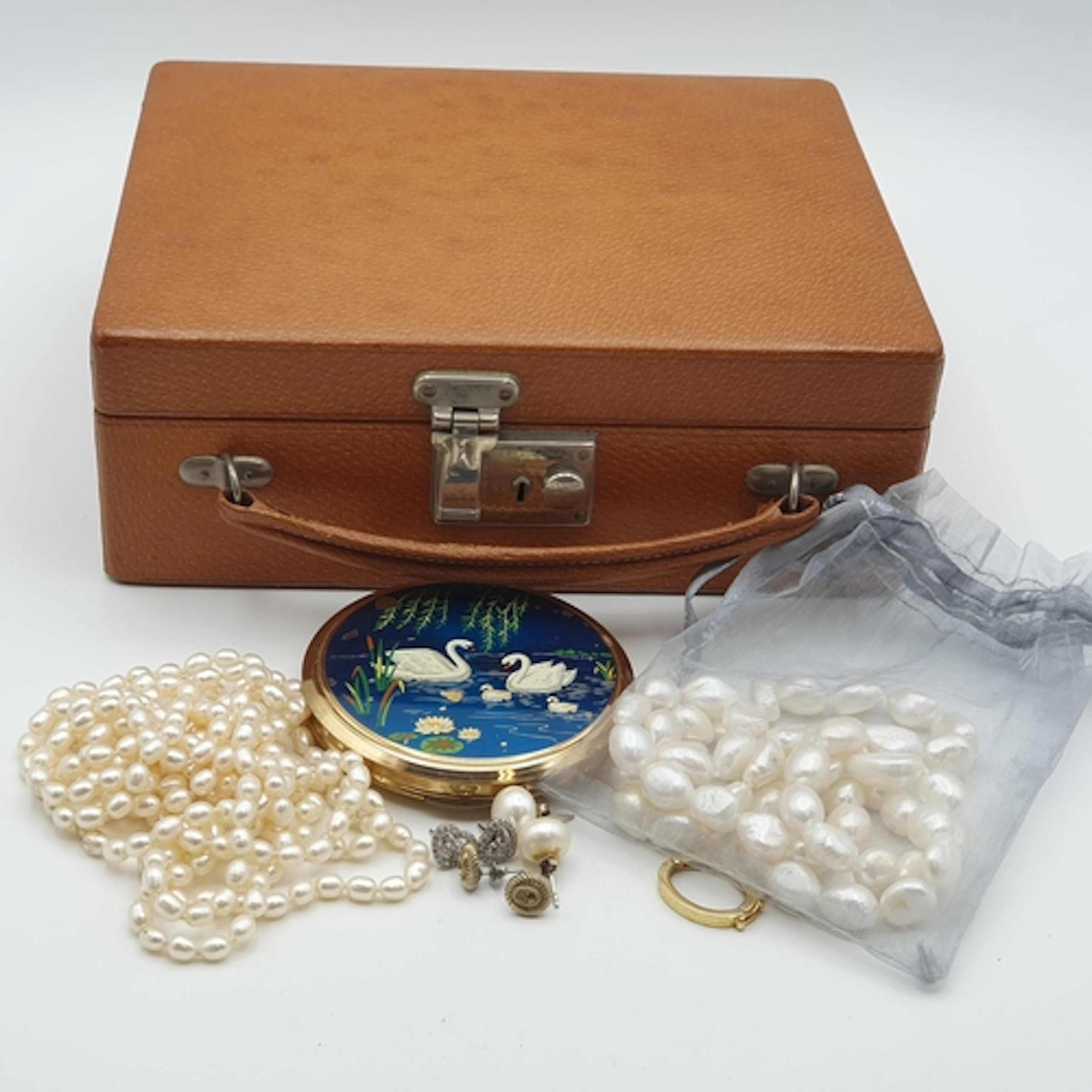 A pig skin leather Jewellery Box containing an opera-length ...