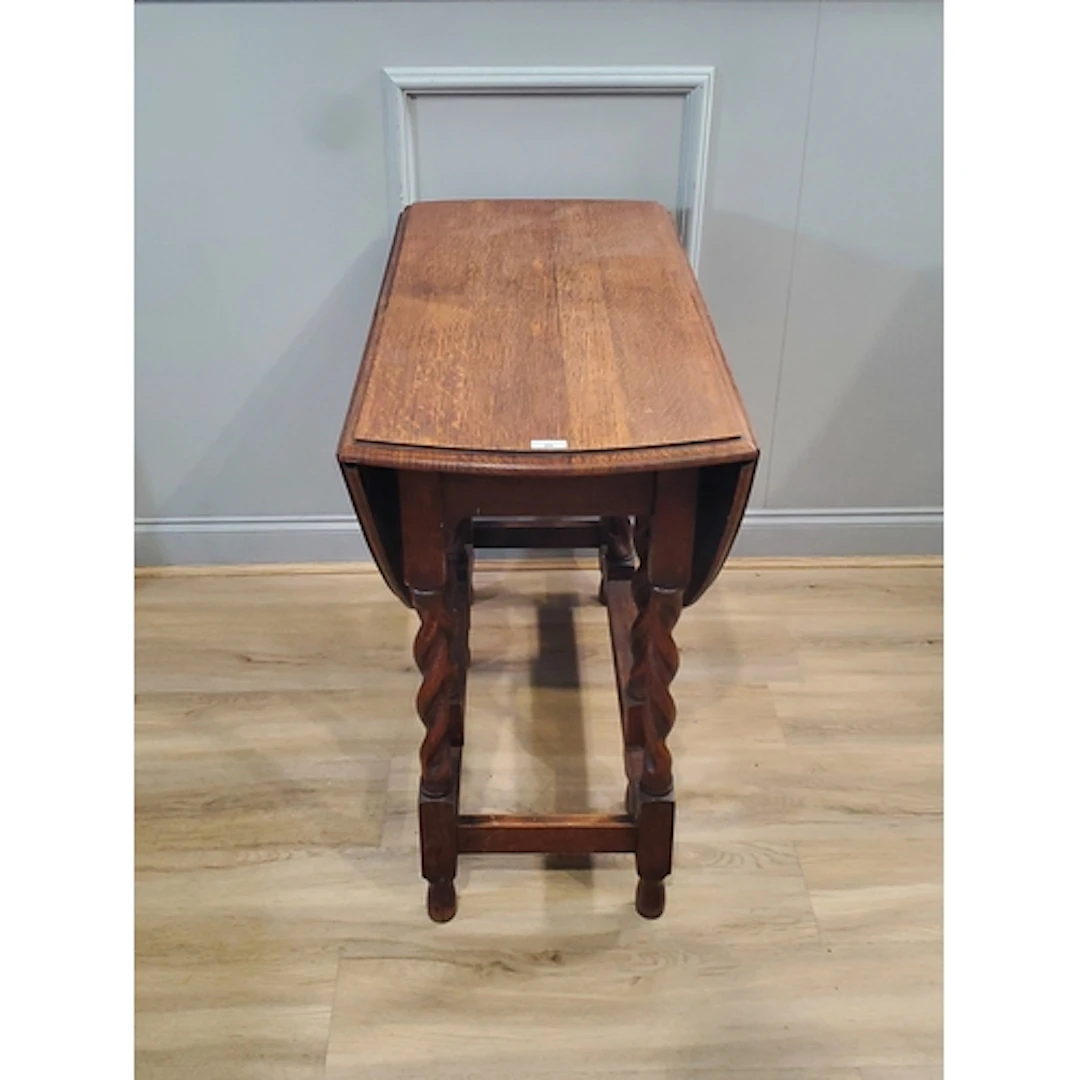An oak Gateleg Table raised on barley twist supports, (R3).