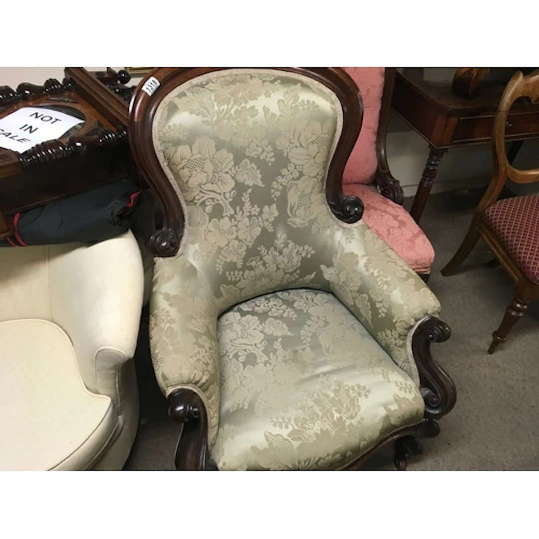 a Victorian mahogany framed armchair, featuring an elegant c...