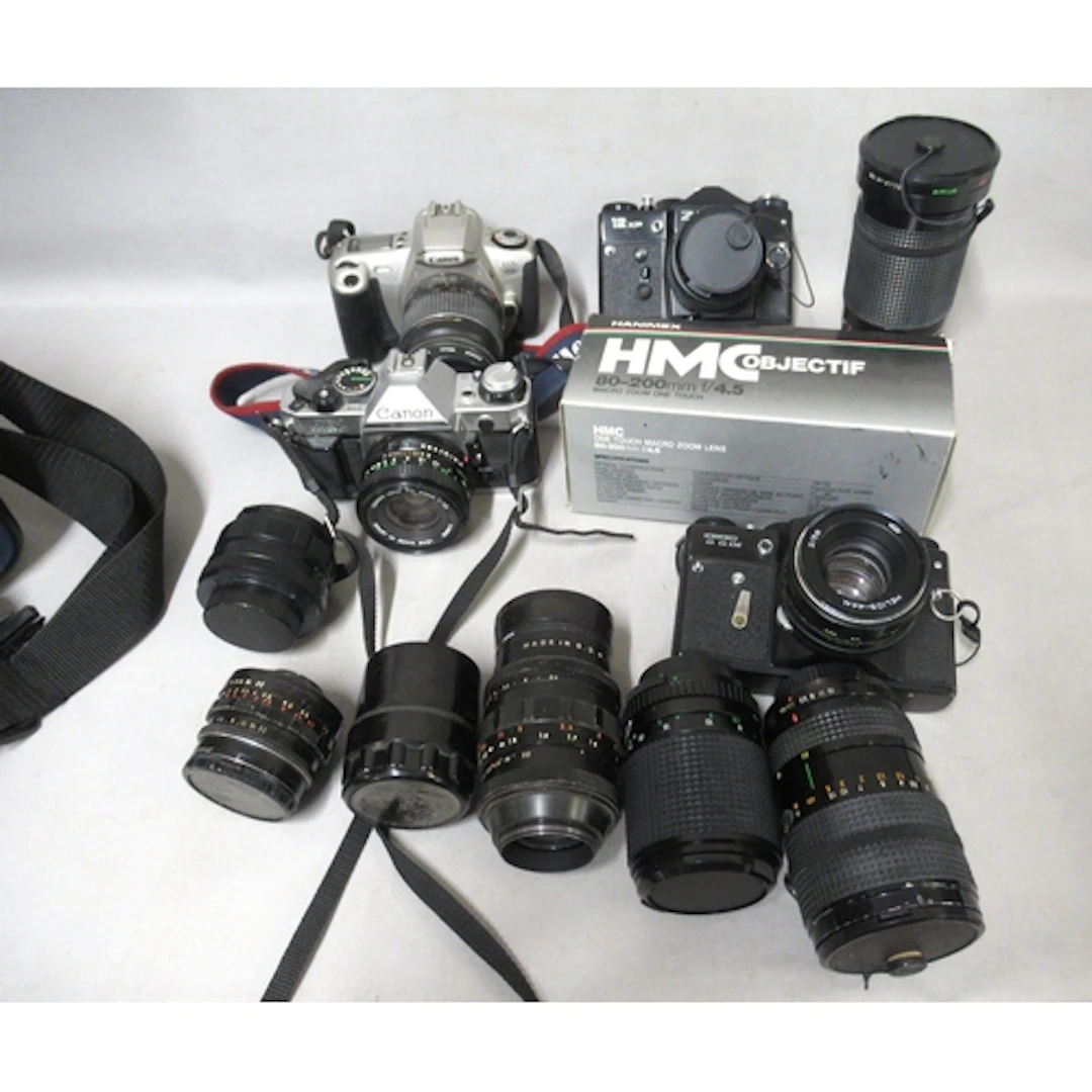 Canon AE-1 35mm camera, together with two Zenit 35mm cameras...