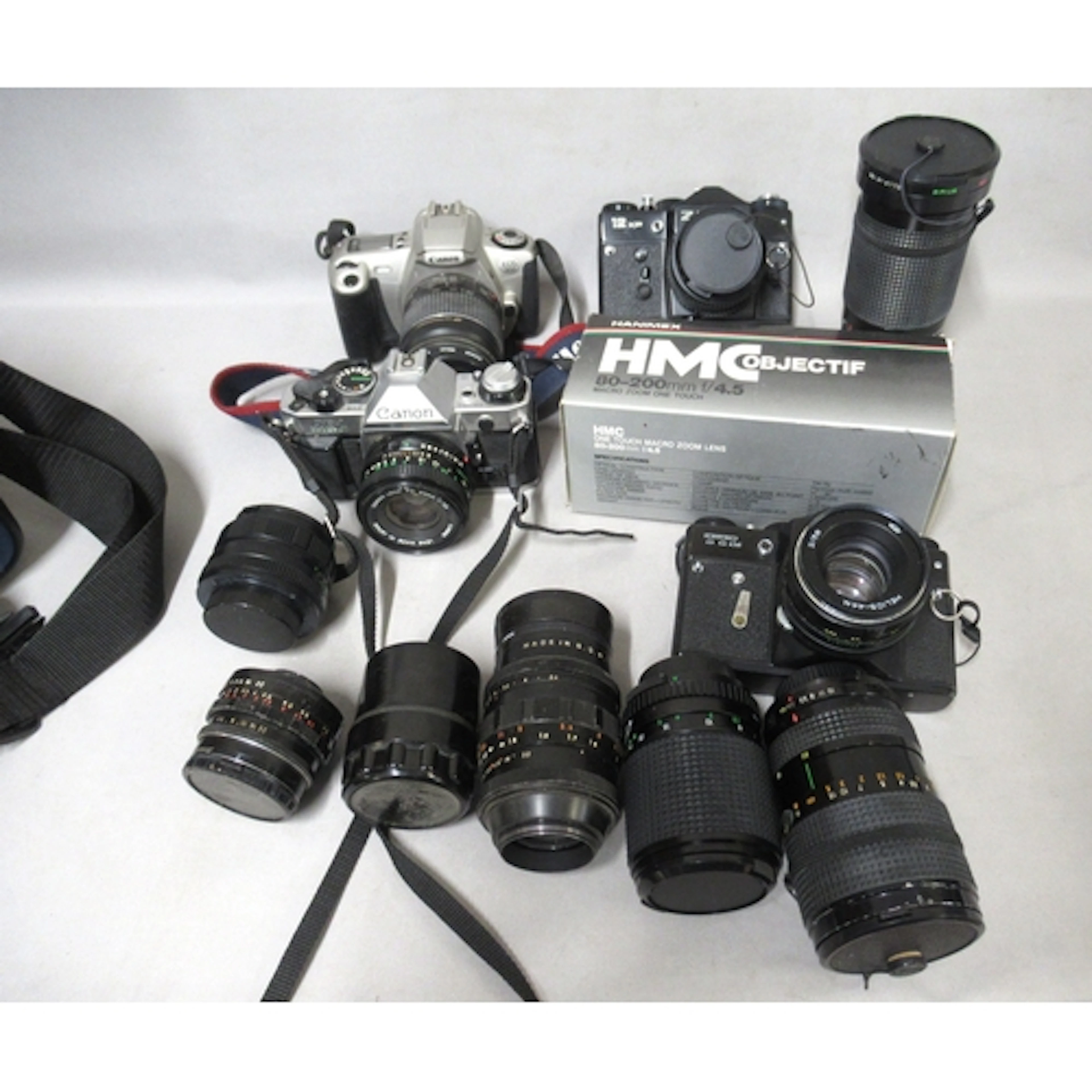 Canon AE-1 35mm camera, together with two Zenit 35mm cameras...
