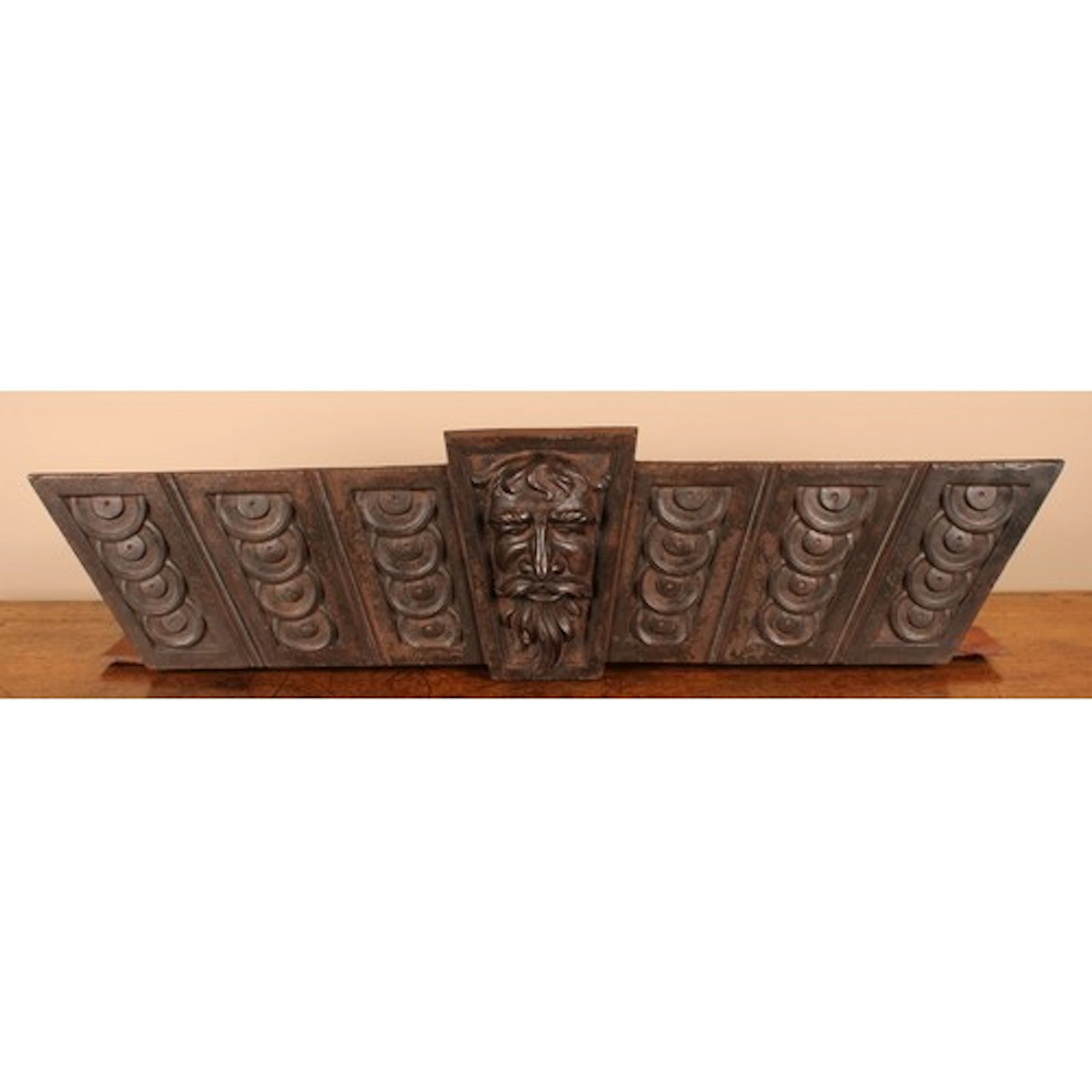 A Derbyshire Arts & Crafts cast iron trapezoid lintel, cast ...