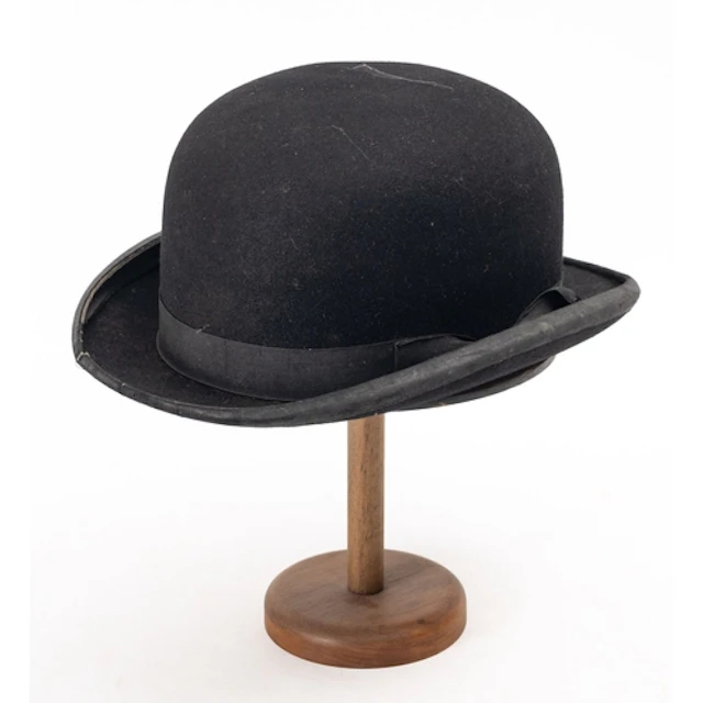 An early 20th Century West & Co black top hat. Having a whit...