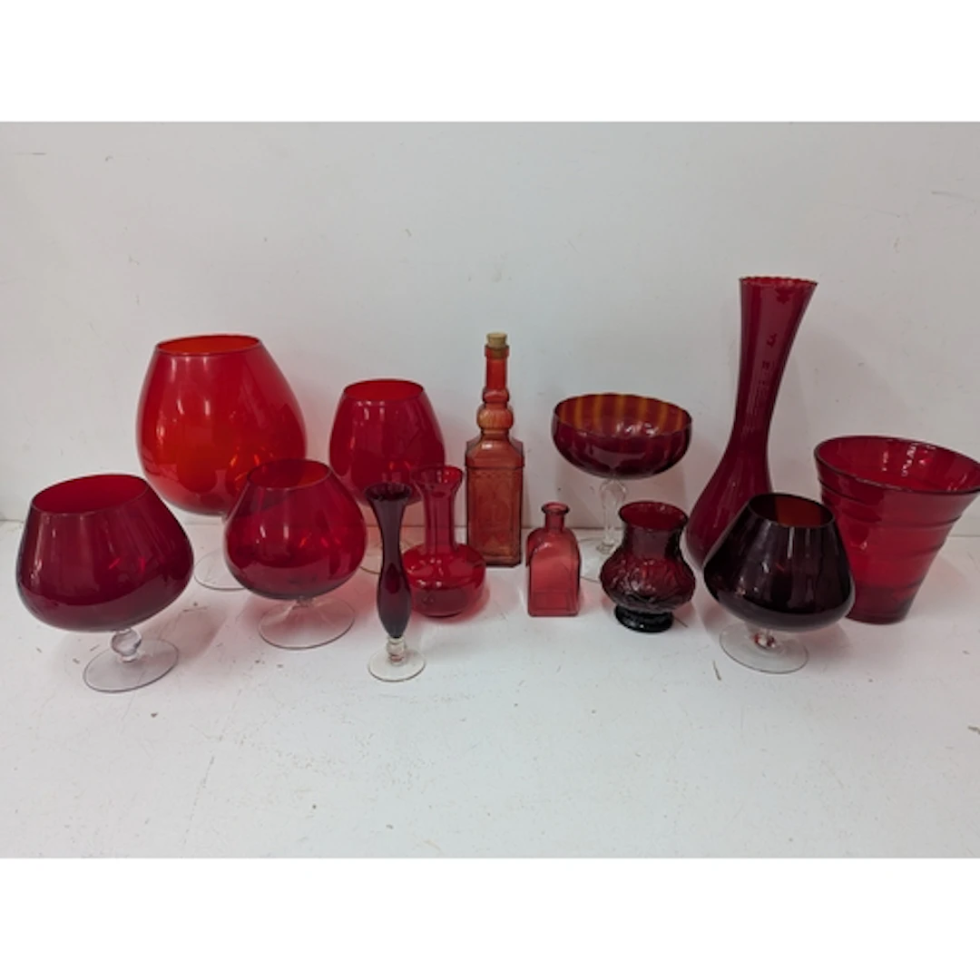 A group of red glass vases and a bottle to include a Whitefr...