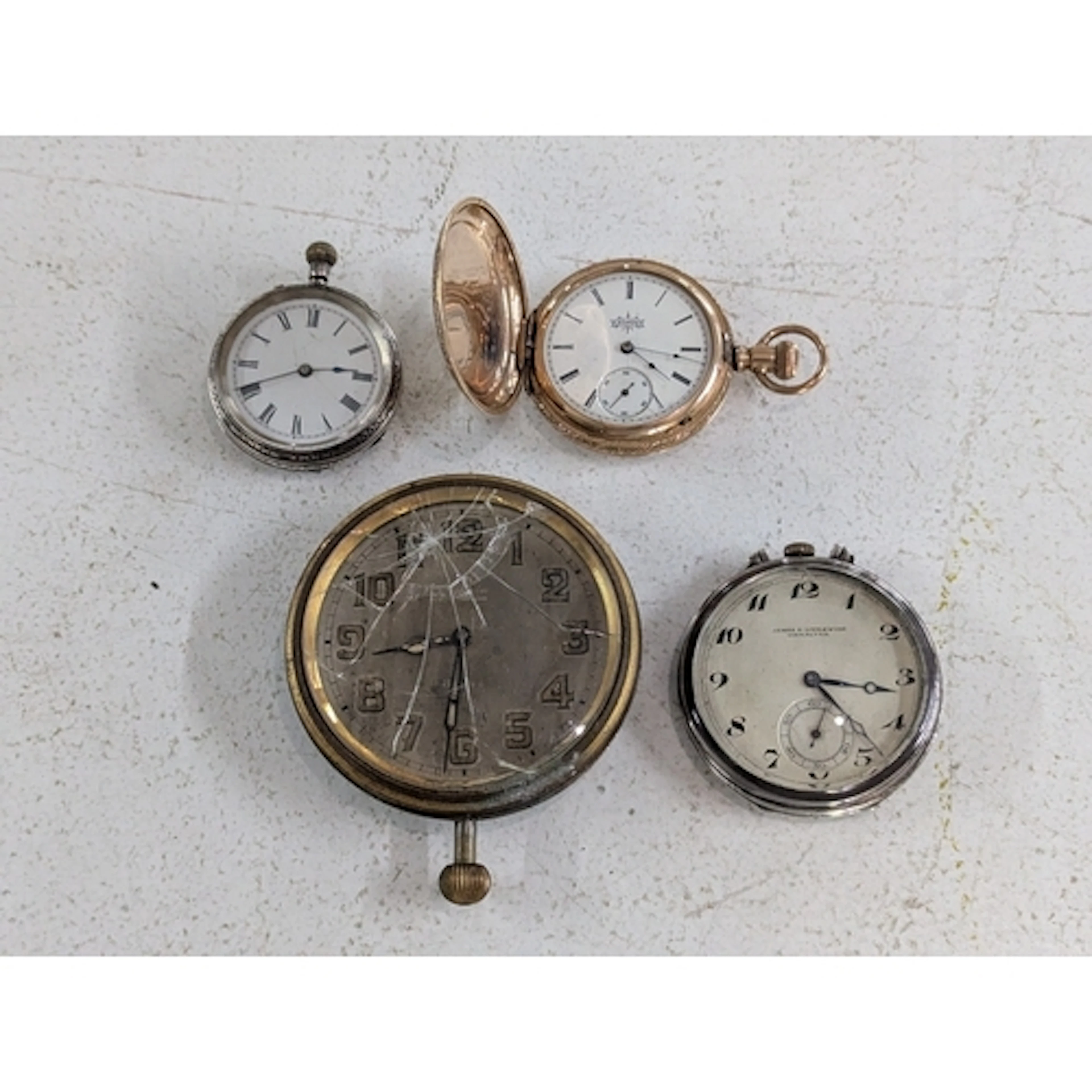 Three pocket watches with a car clock, a gold-plated example...