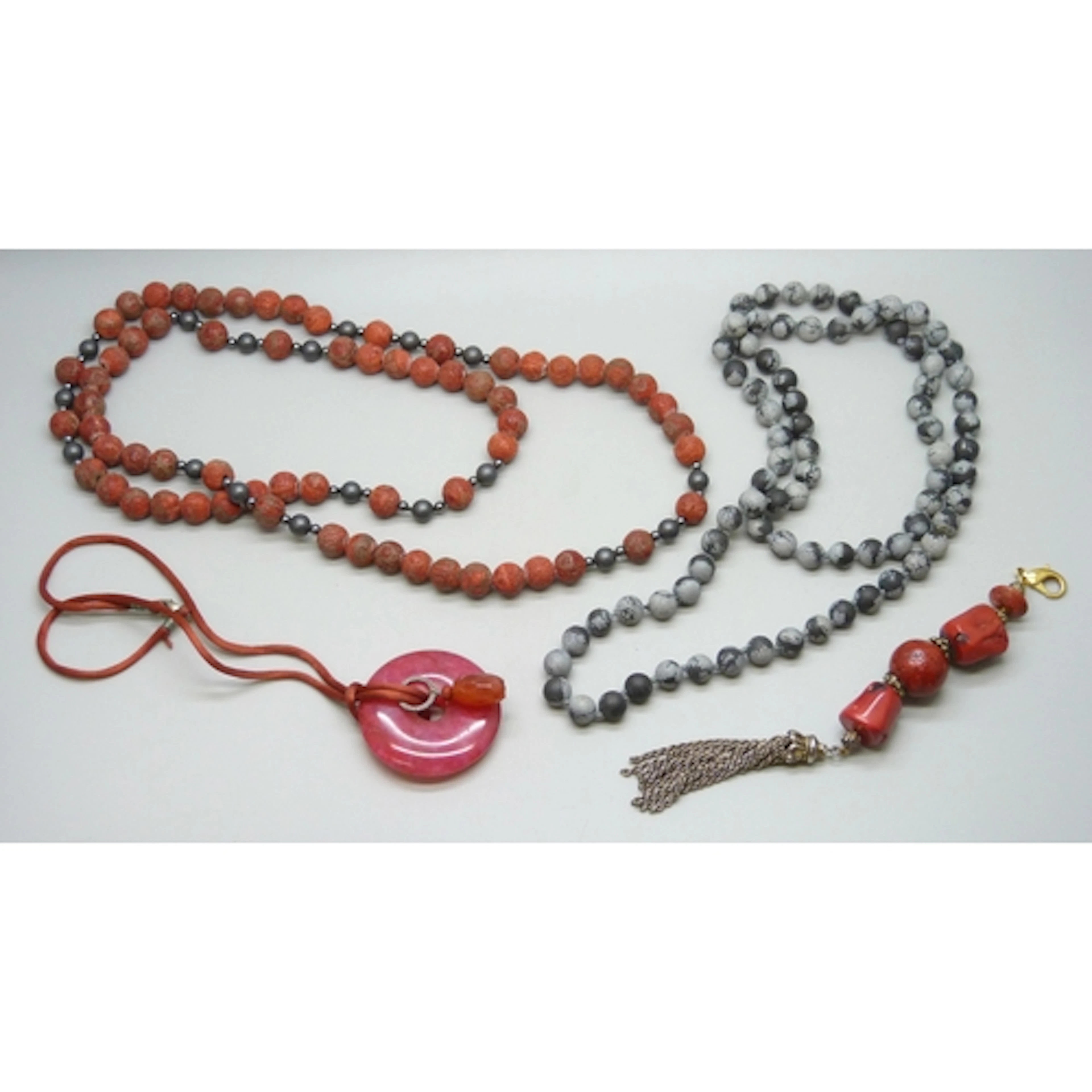 A possibly coral necklace, a snowflake obsidian necklace, a ...