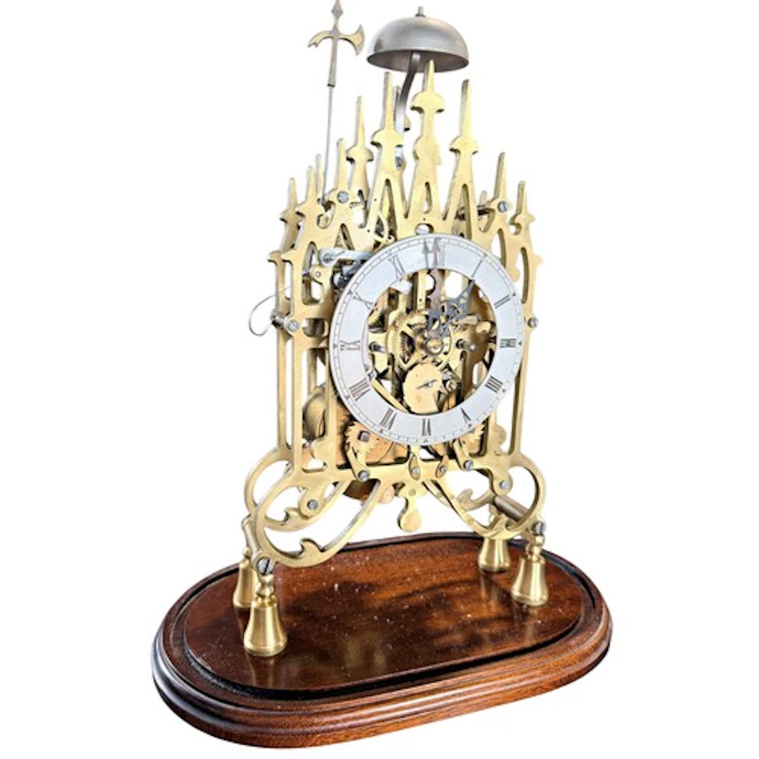A 19th century brass 'cathedral' skeleton clock, twin fusee ...