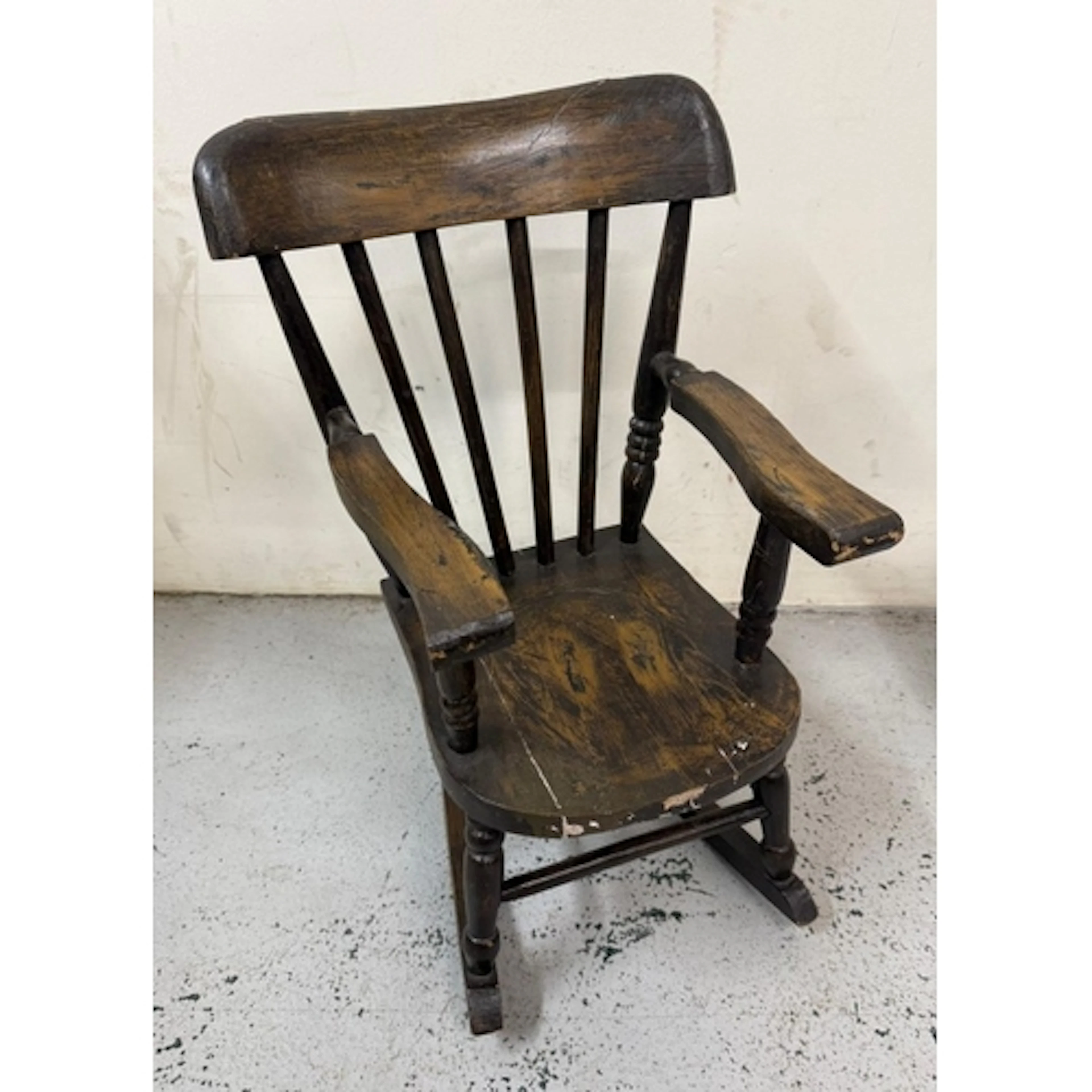 A vintage oak child's rocking chair