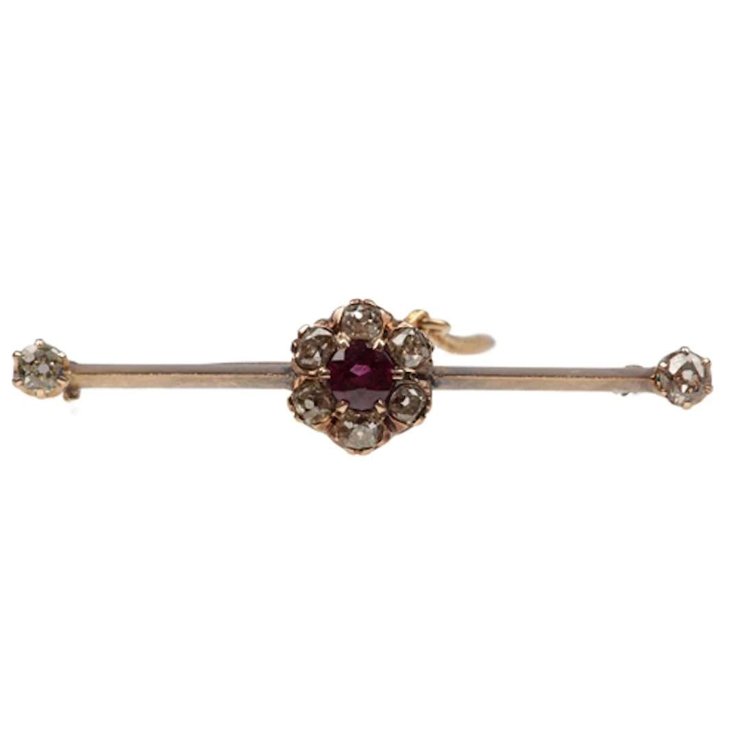 A garnet and diamond bar brooch, early 20th century, centrin...