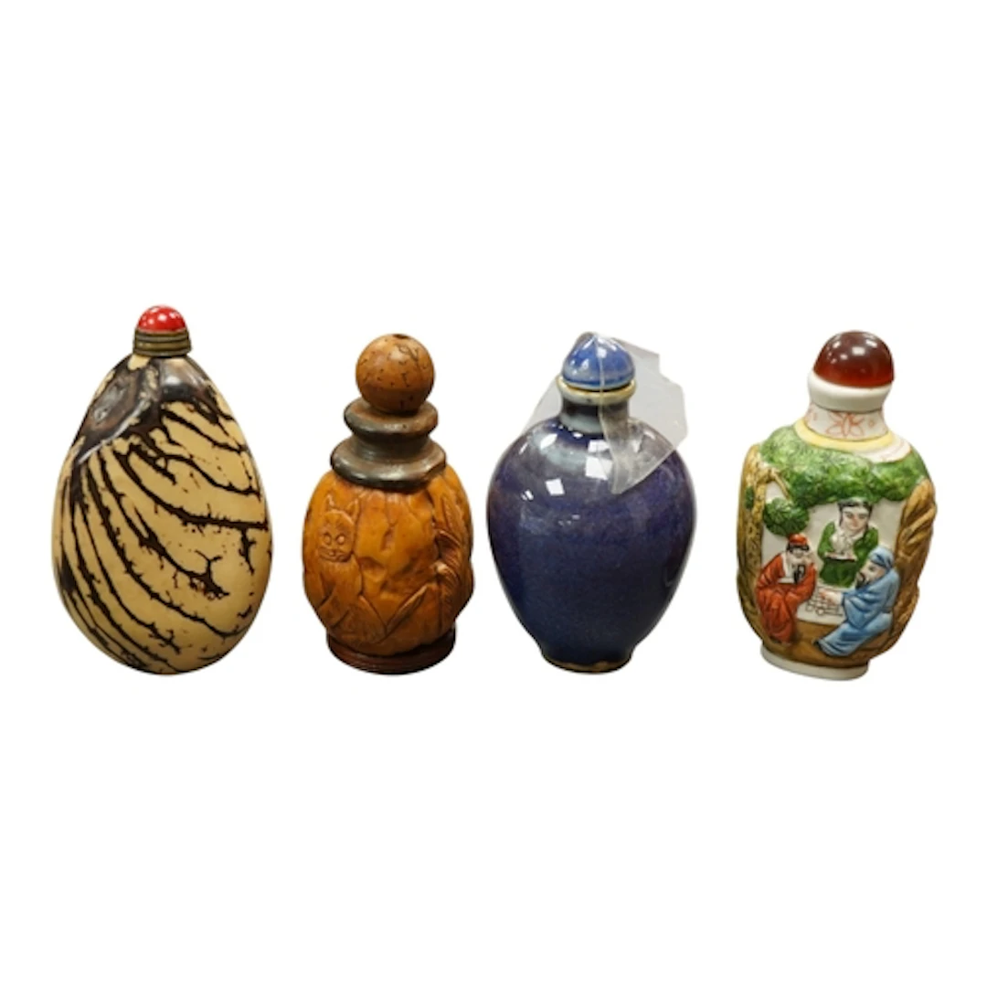 Four Chinese snuff bottles to include a carved treen and nut...