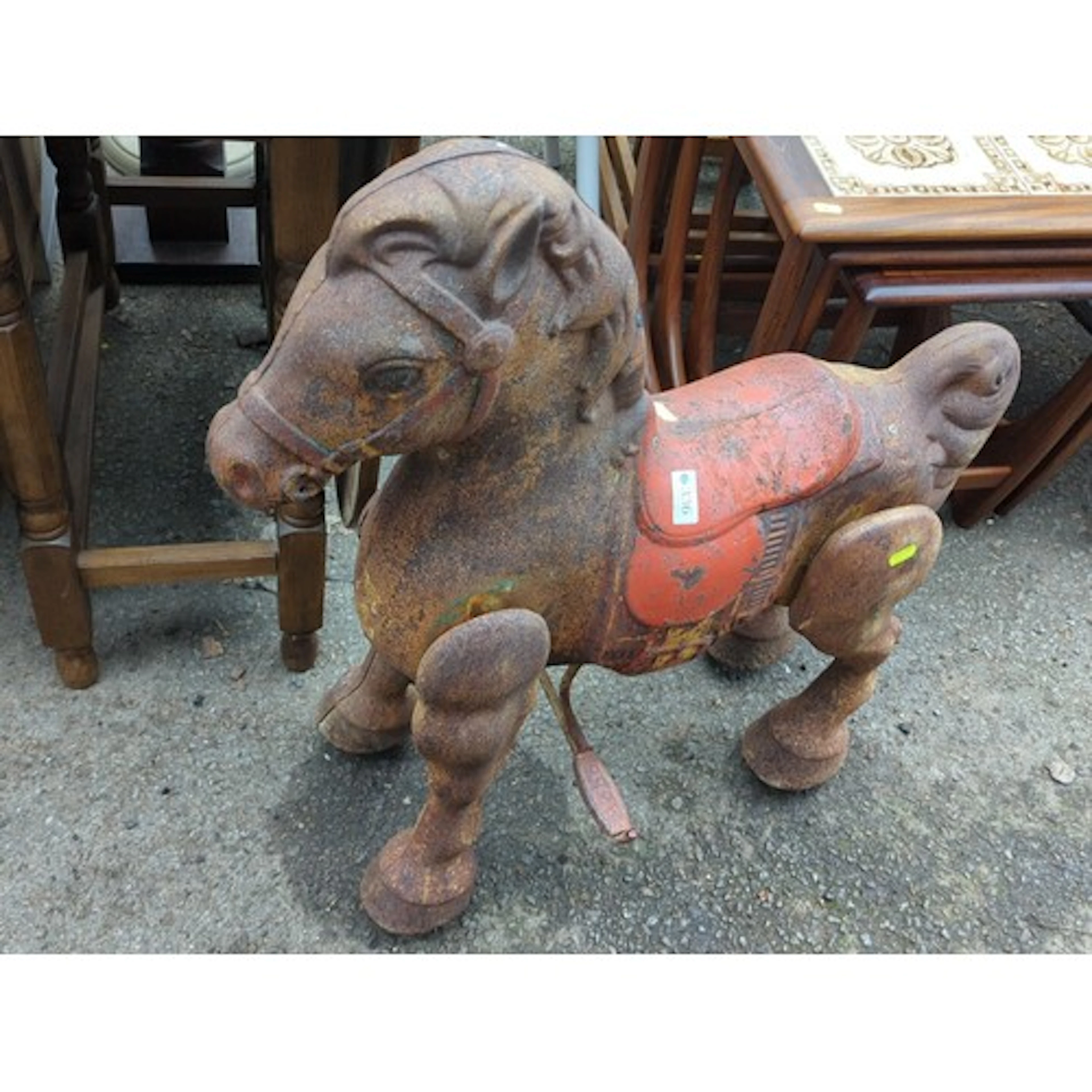 20th century cast iron toy horse on wheels, with red-painted...
