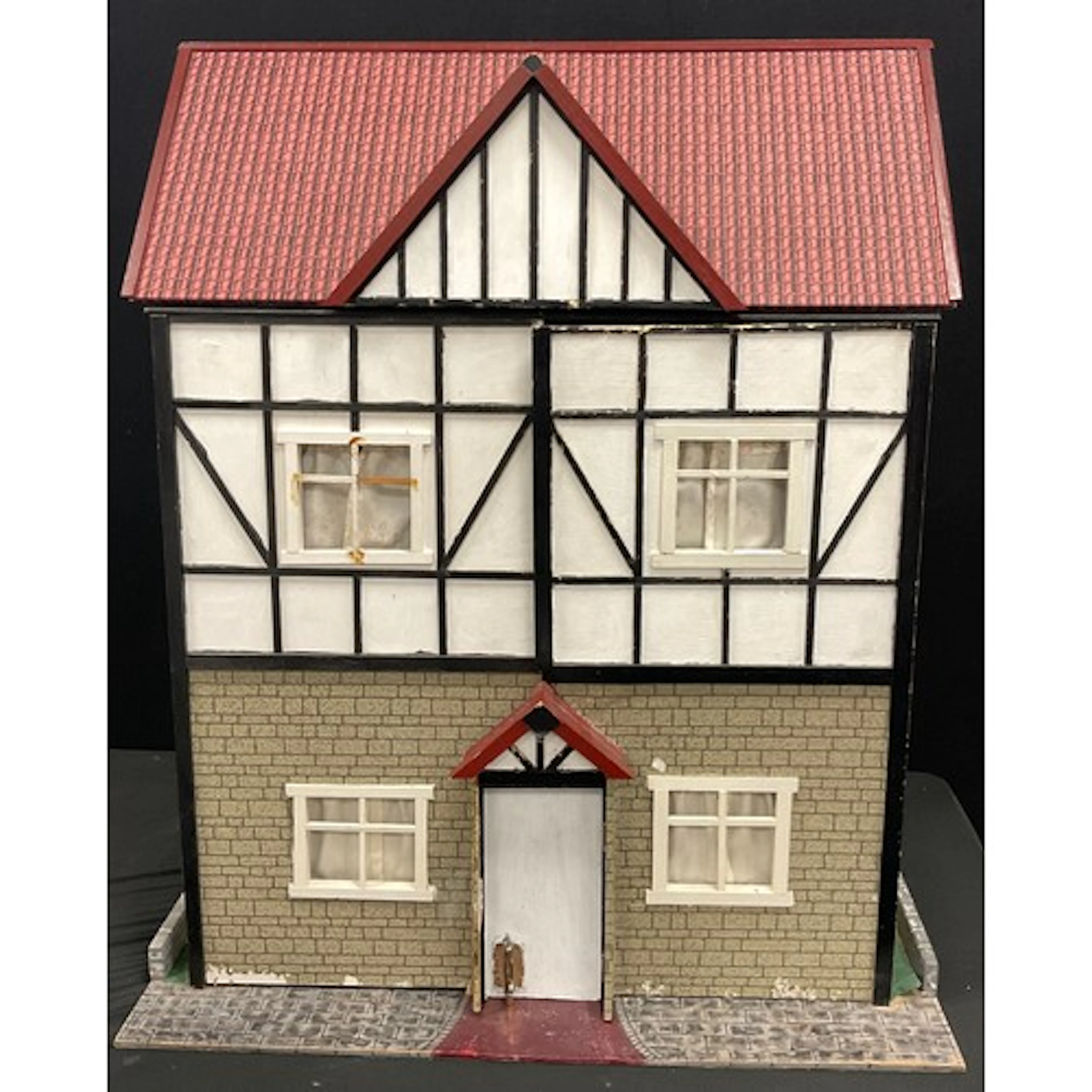 A two story dolls house, in the form of a mock Tudor style t...