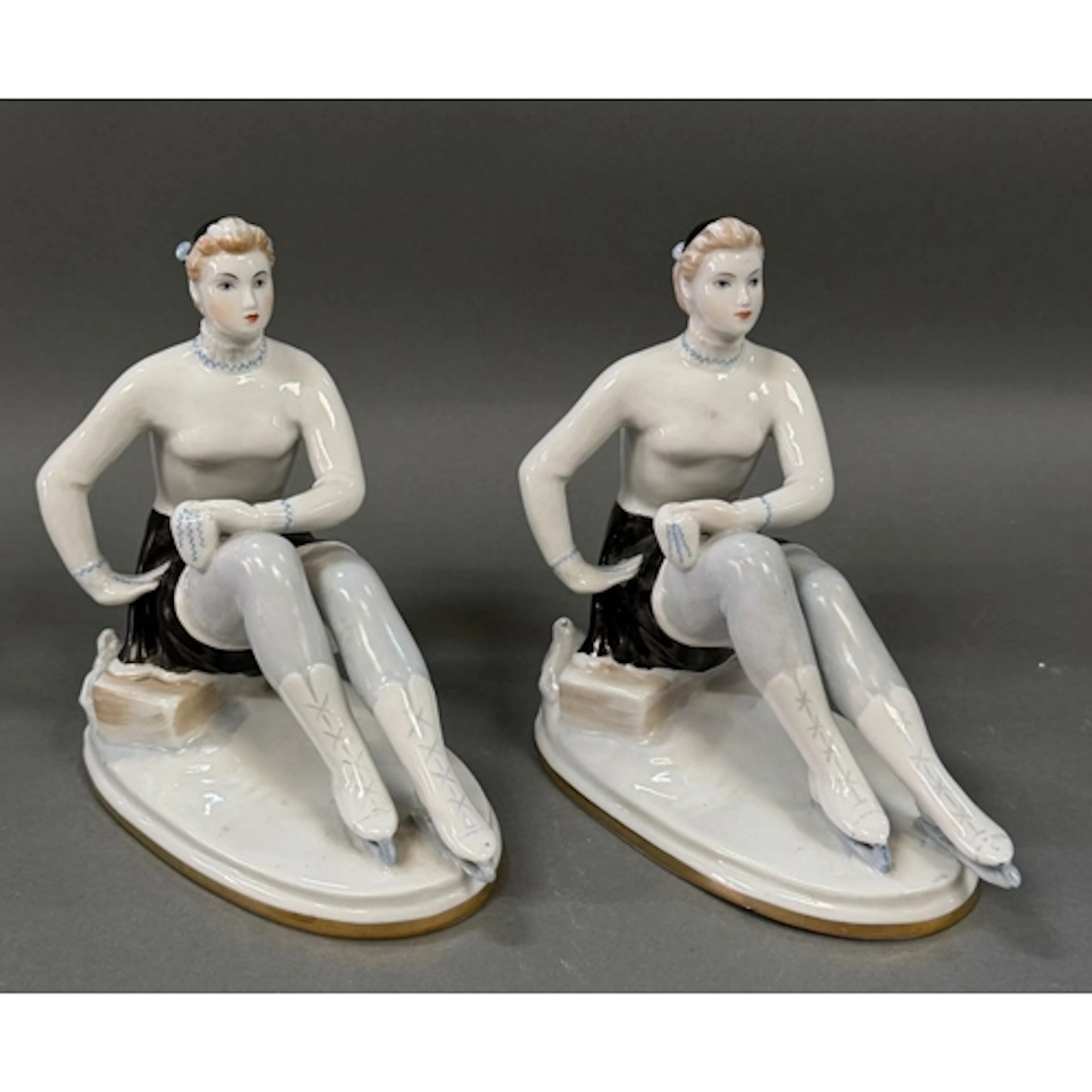 A pair of porcelain figurines of figure skaters made and sta...