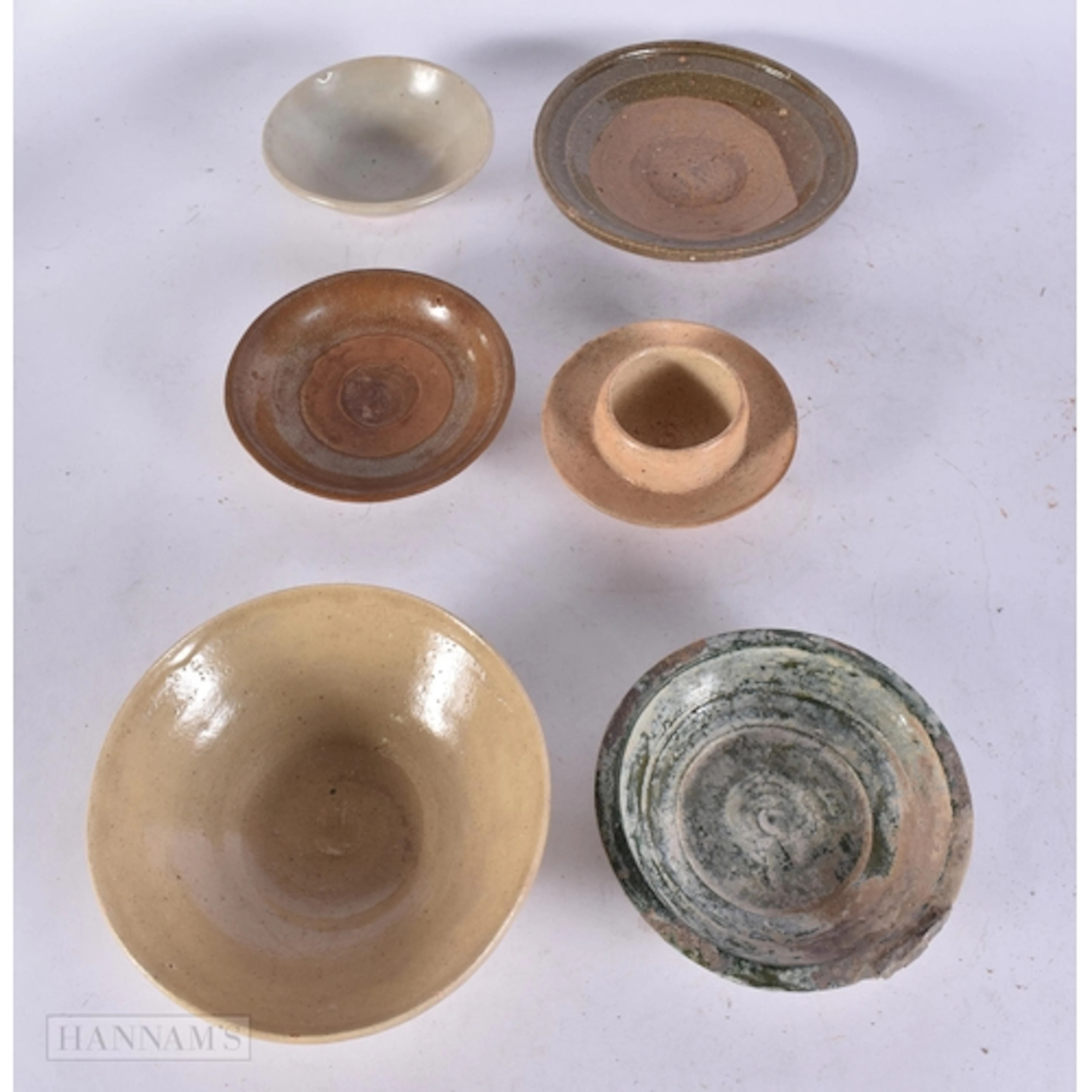 A GROUP OF EARLY CHINESE BOWLS AND SAUCERS Han Dynasty and l...