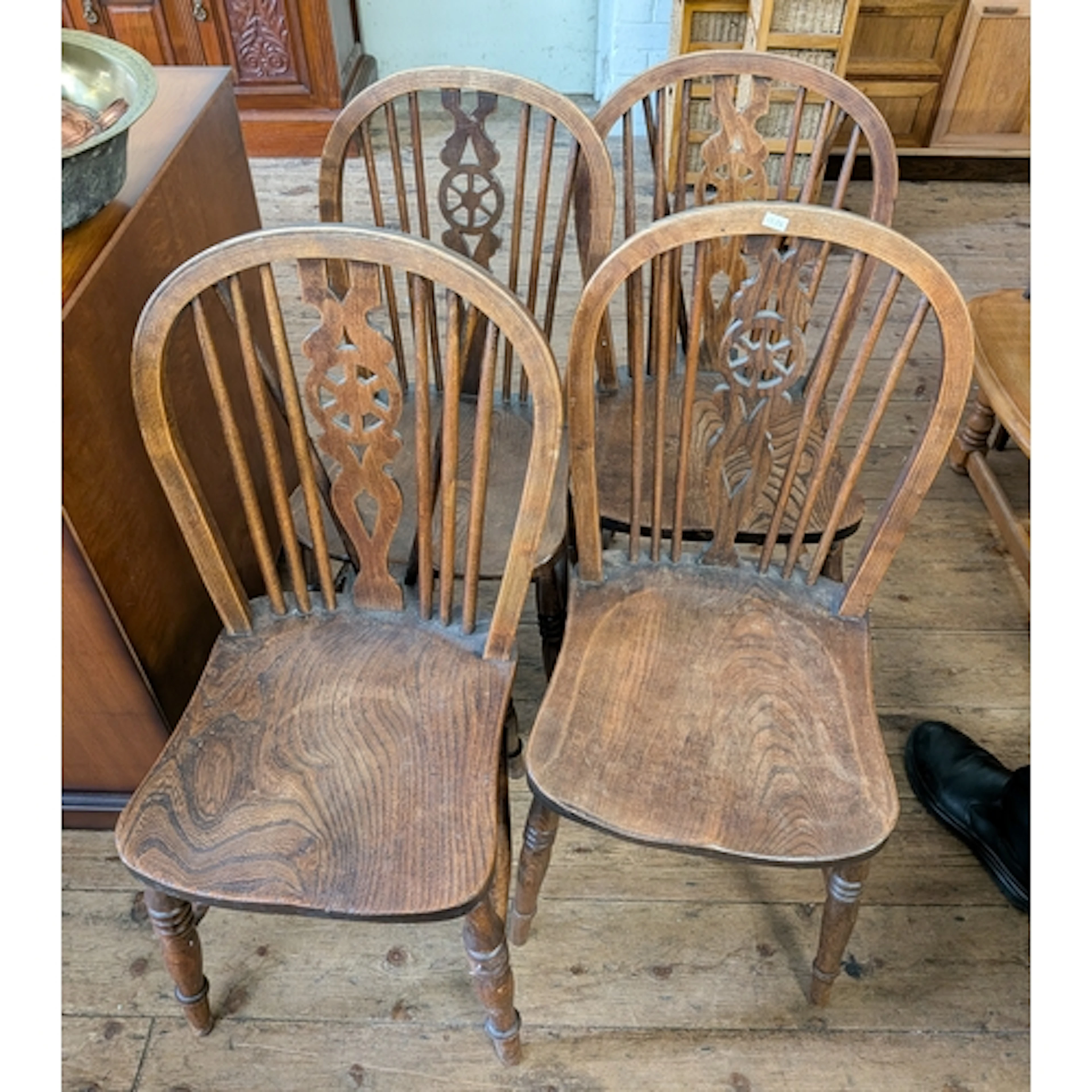 A set of elm wheel backed Windsor dining room chairs