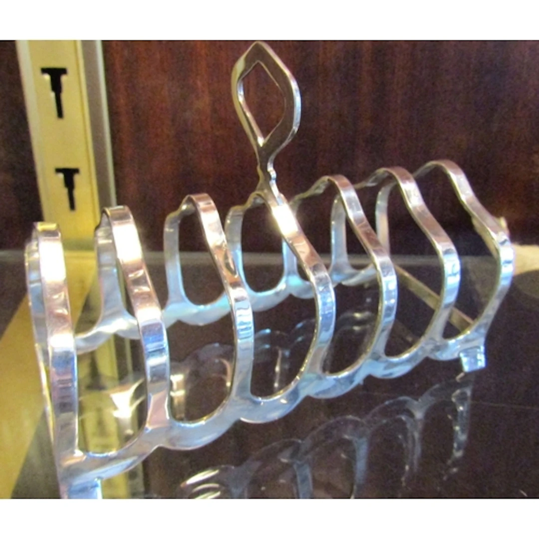 Antique Silver Six Slice Toast Rack Integral Handle Above Sh...