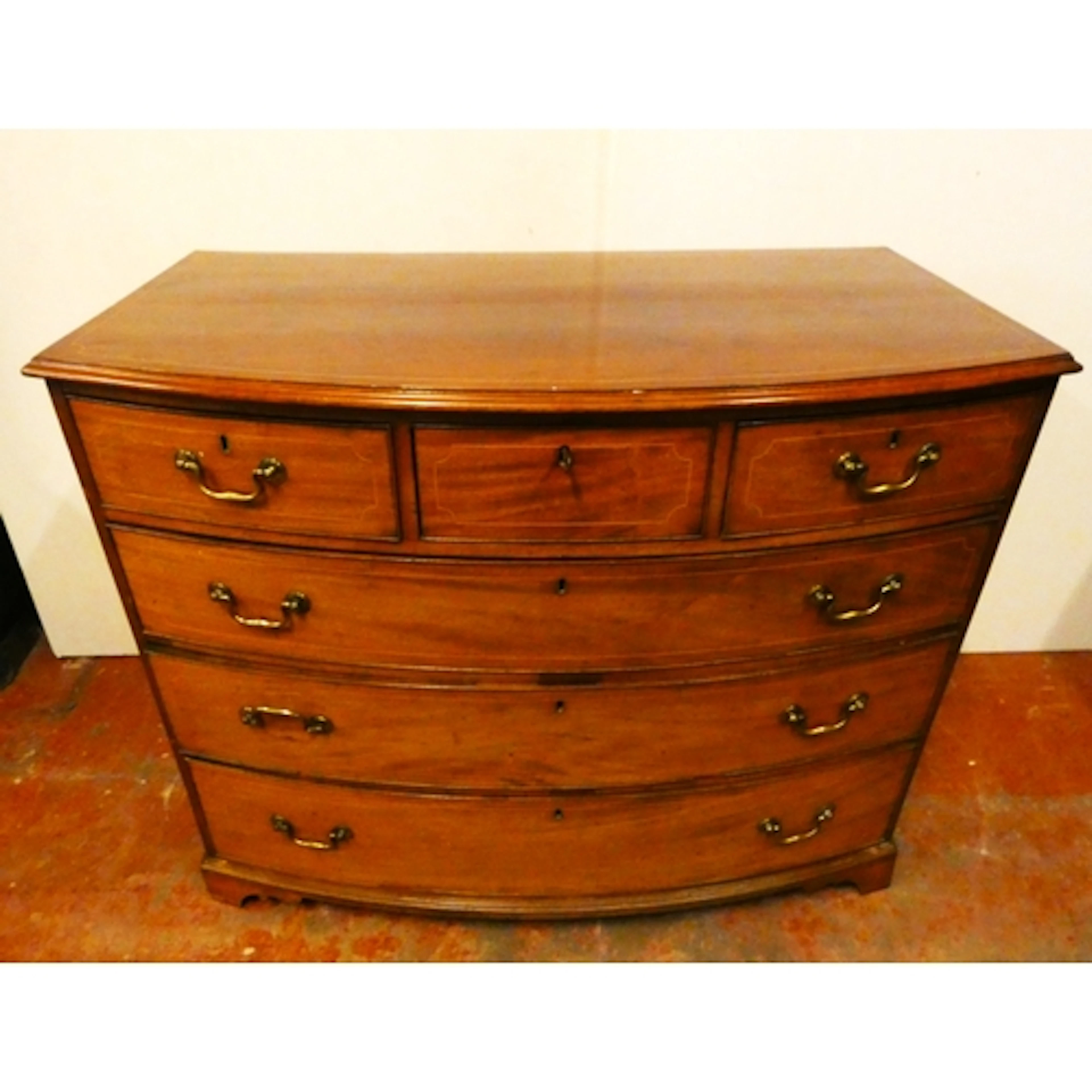 George IV inlaid mahogany bowfront chest of drawers, with th...