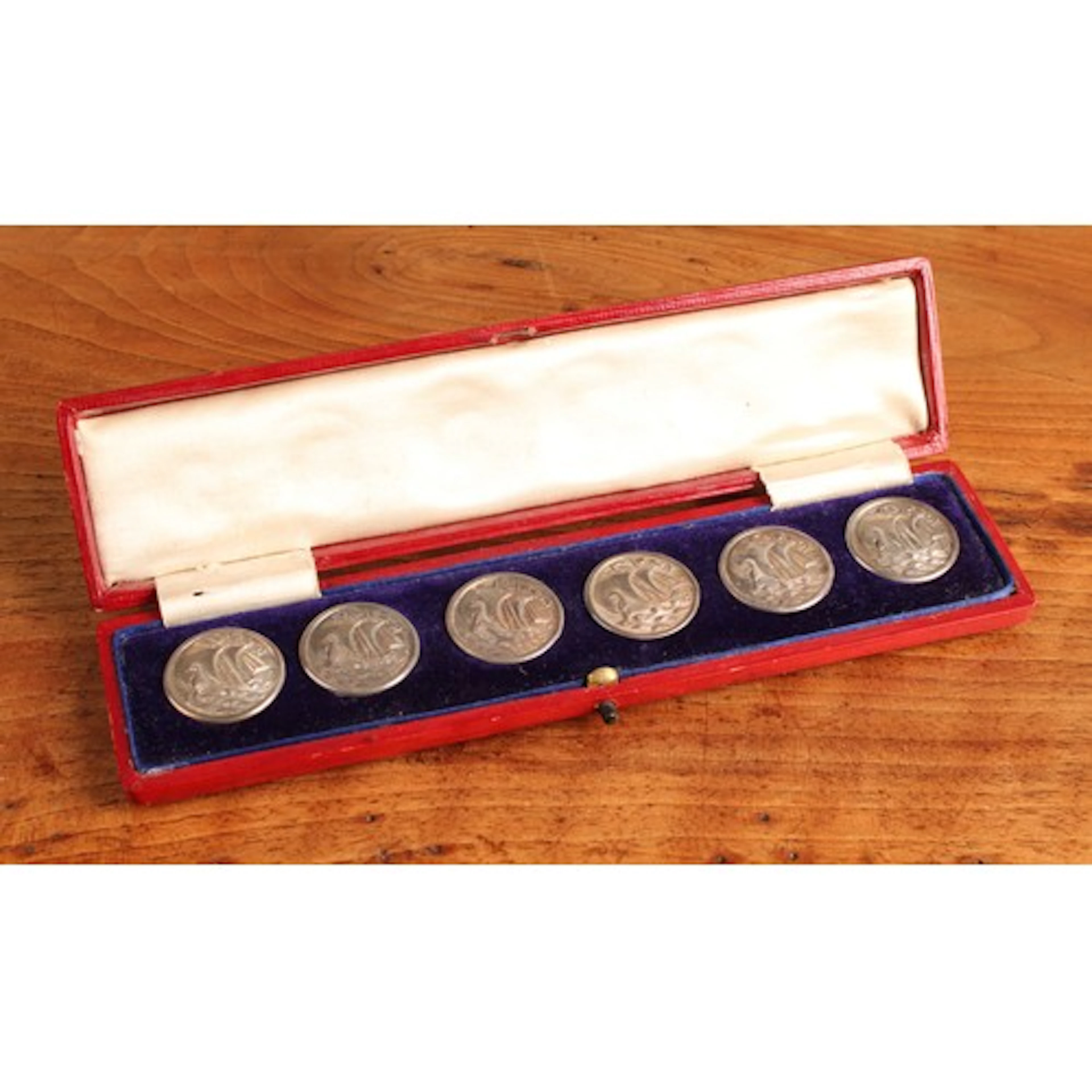 A set of six Arts and Crafts silver buttons, each in relief ...