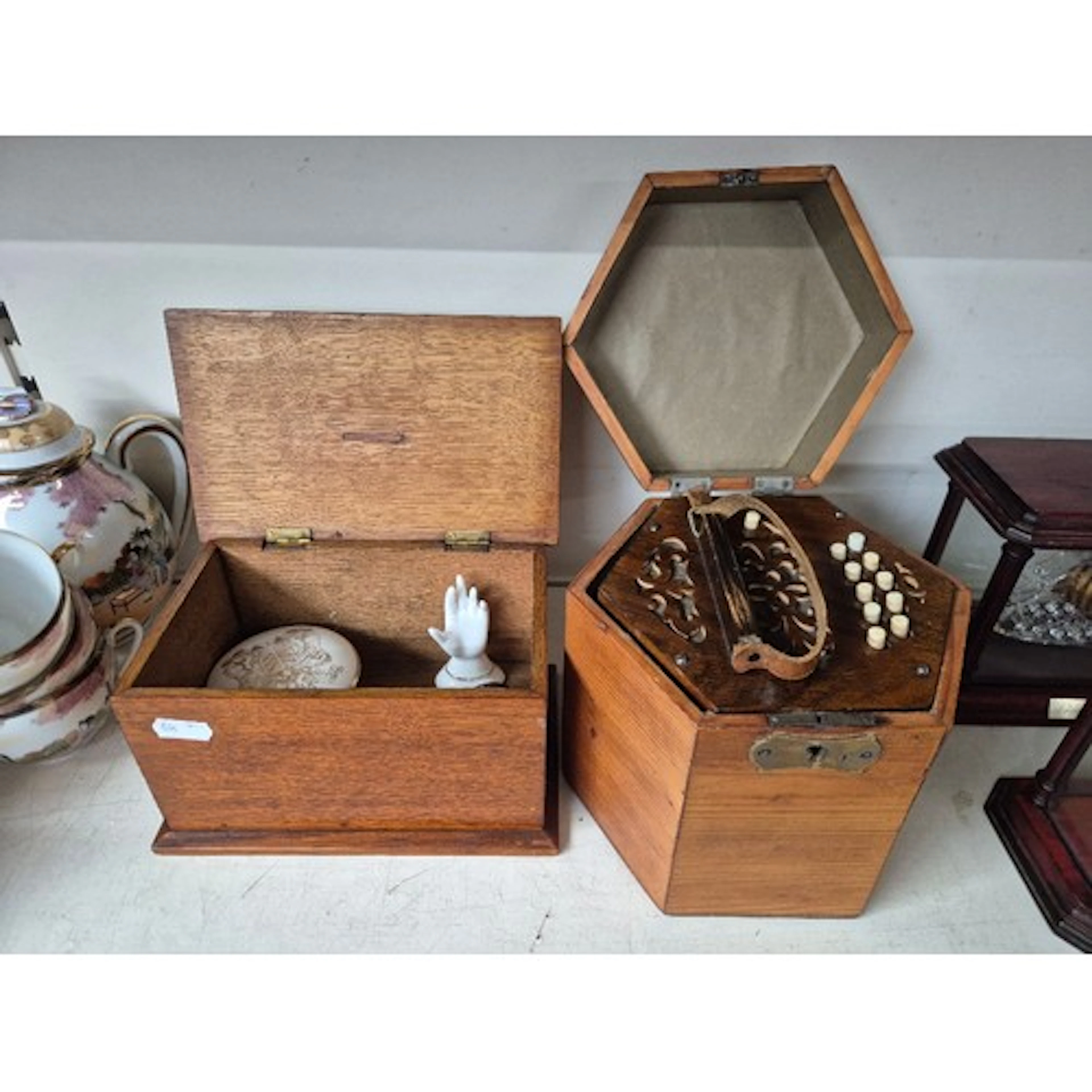 An Anglo concertina in a fitted hexagonal wooden case and an...
