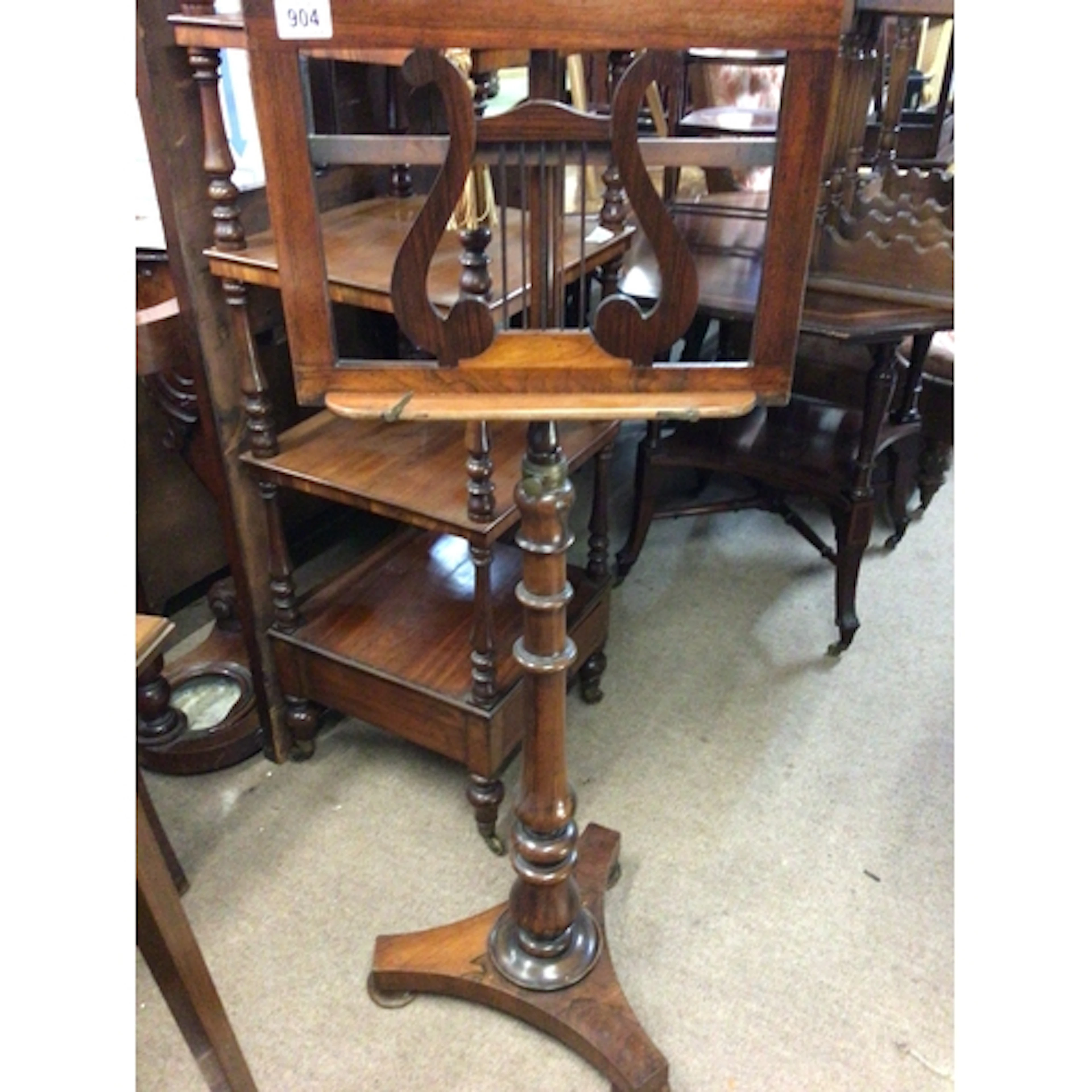 A quality Victorian Rosewood music stand with a harp s...