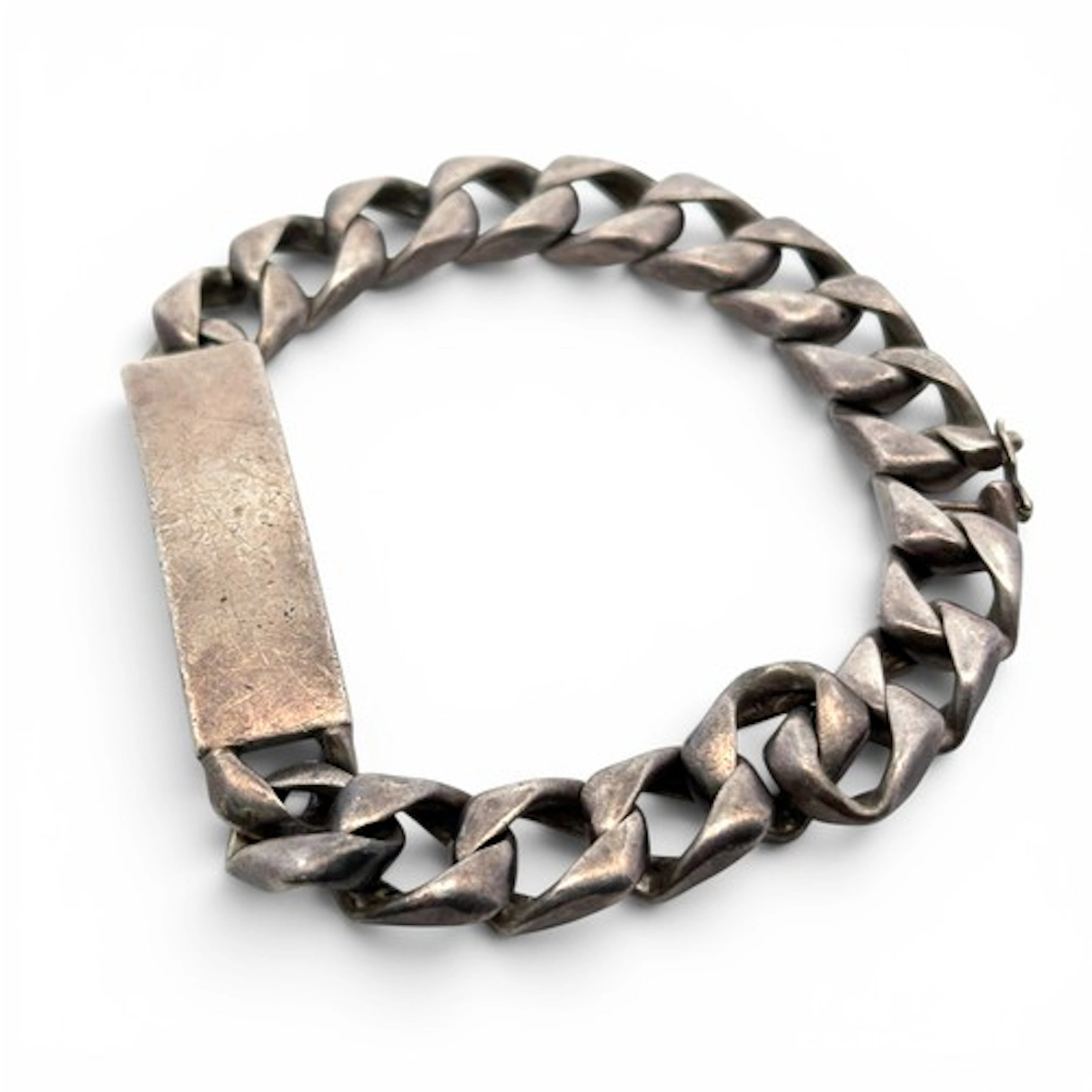 A silver identity bracelet, the name is rubbed and illegible...