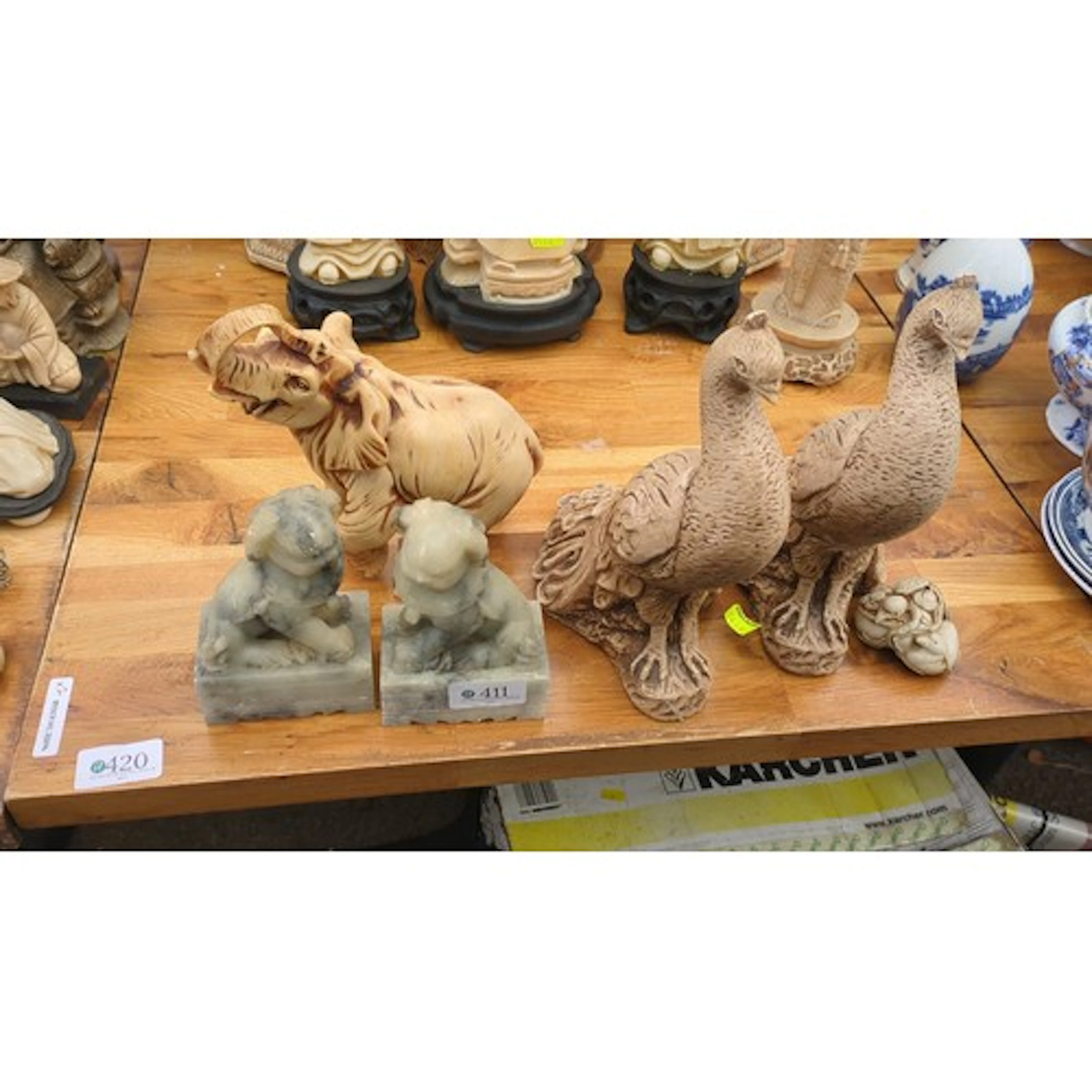 A group of Asian decorative carvings and figures, including ...