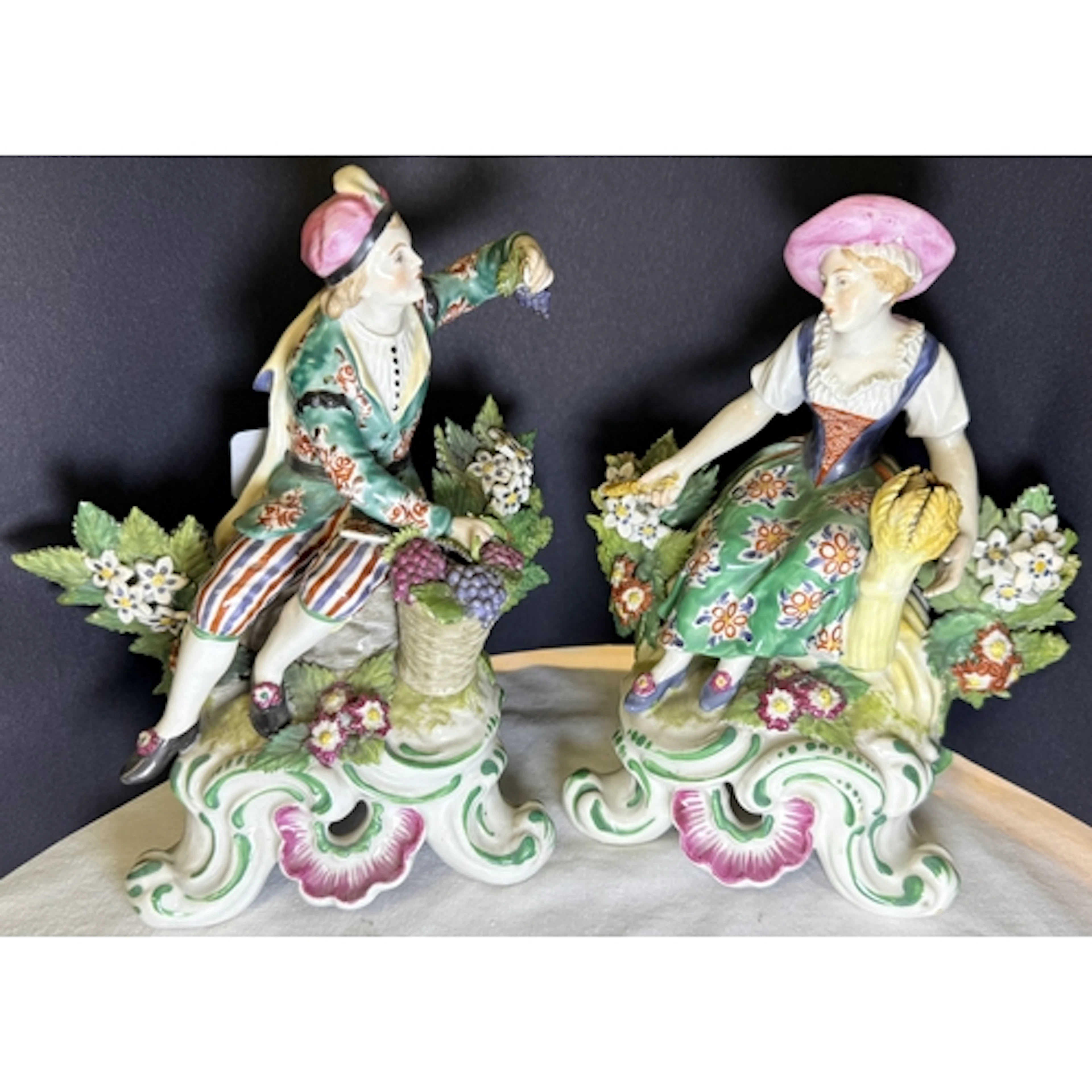 A pair of 19th century Chelsea style porcelain figures of a ...