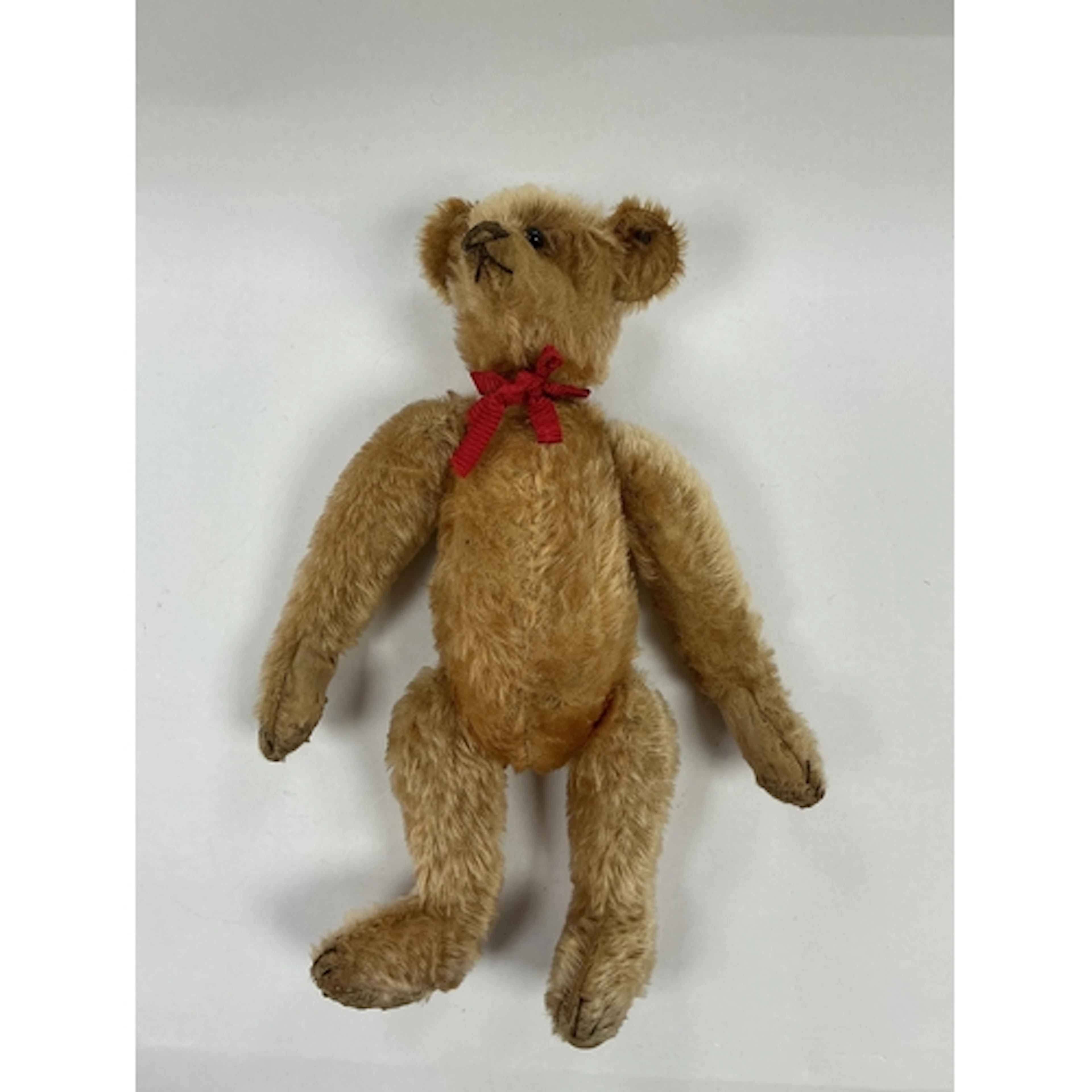 An early 20th century Steiff bear with jointed limbs and but...