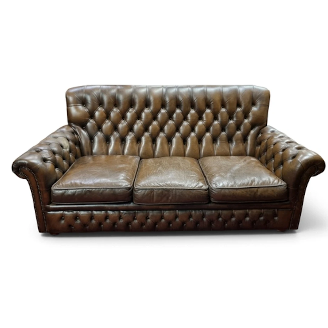 A 20th Century Chesterfield style deep buttoned three seater...