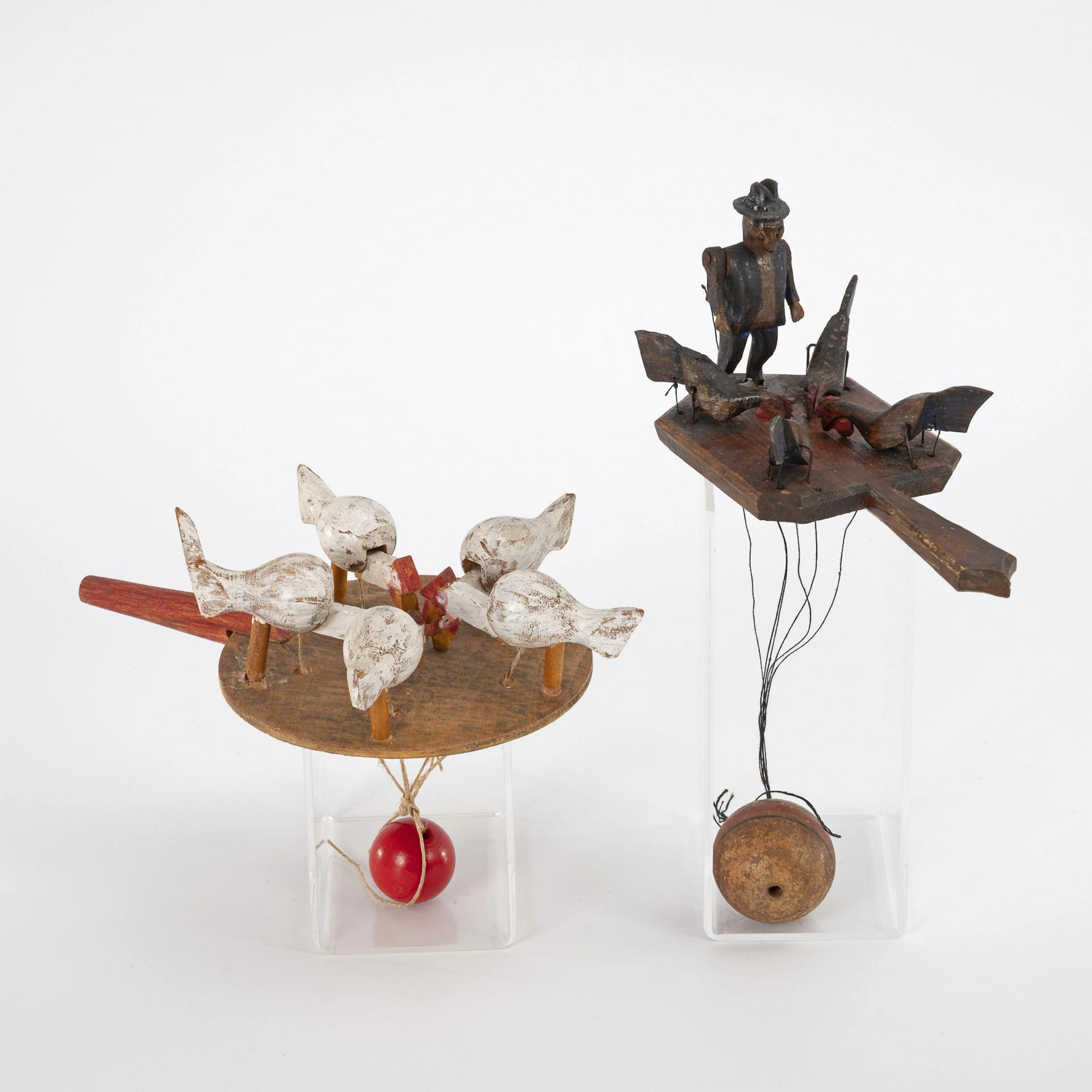 2 hand toys with pecking chickens.