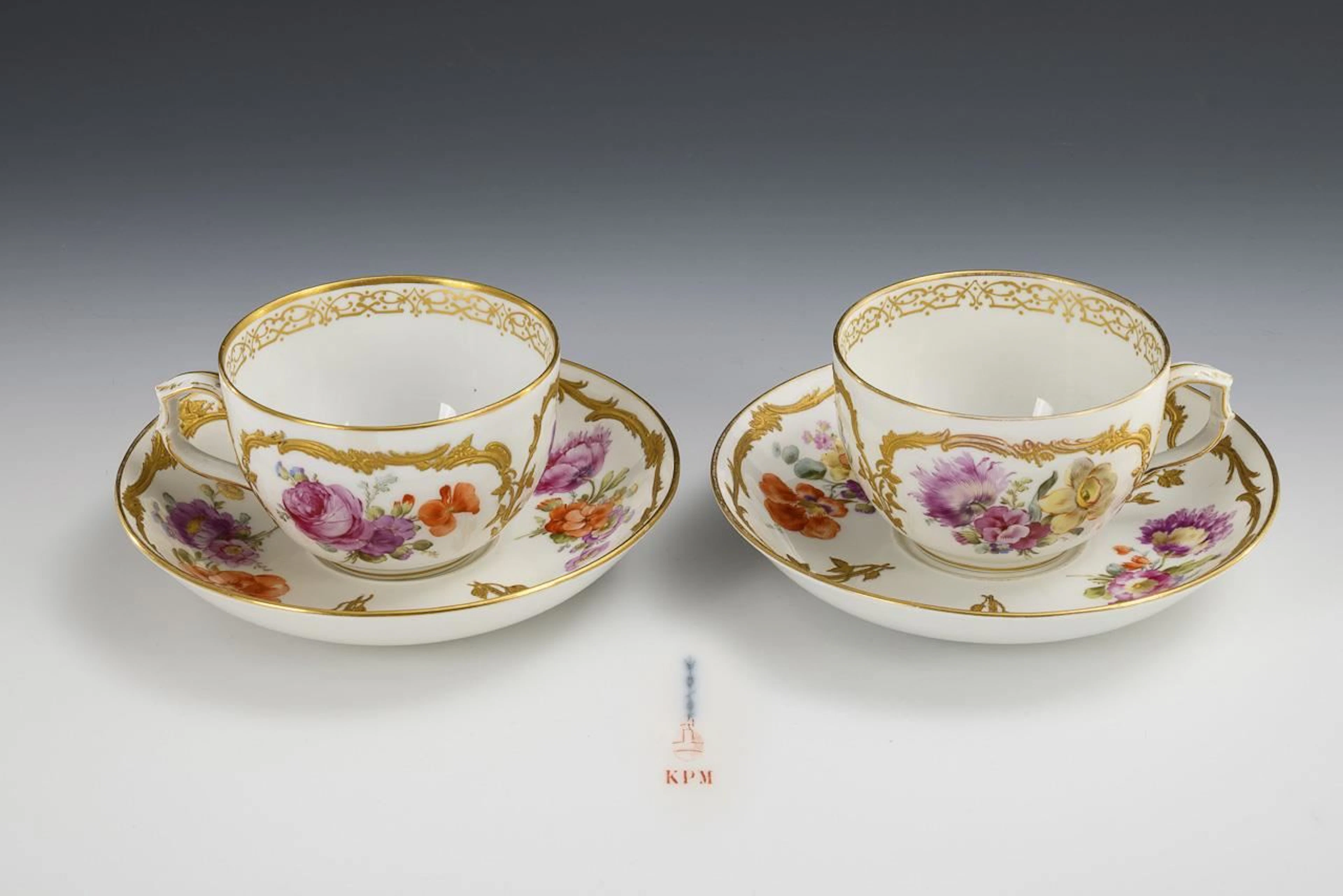 2 large teacups with floral designs. KPM Berlin.